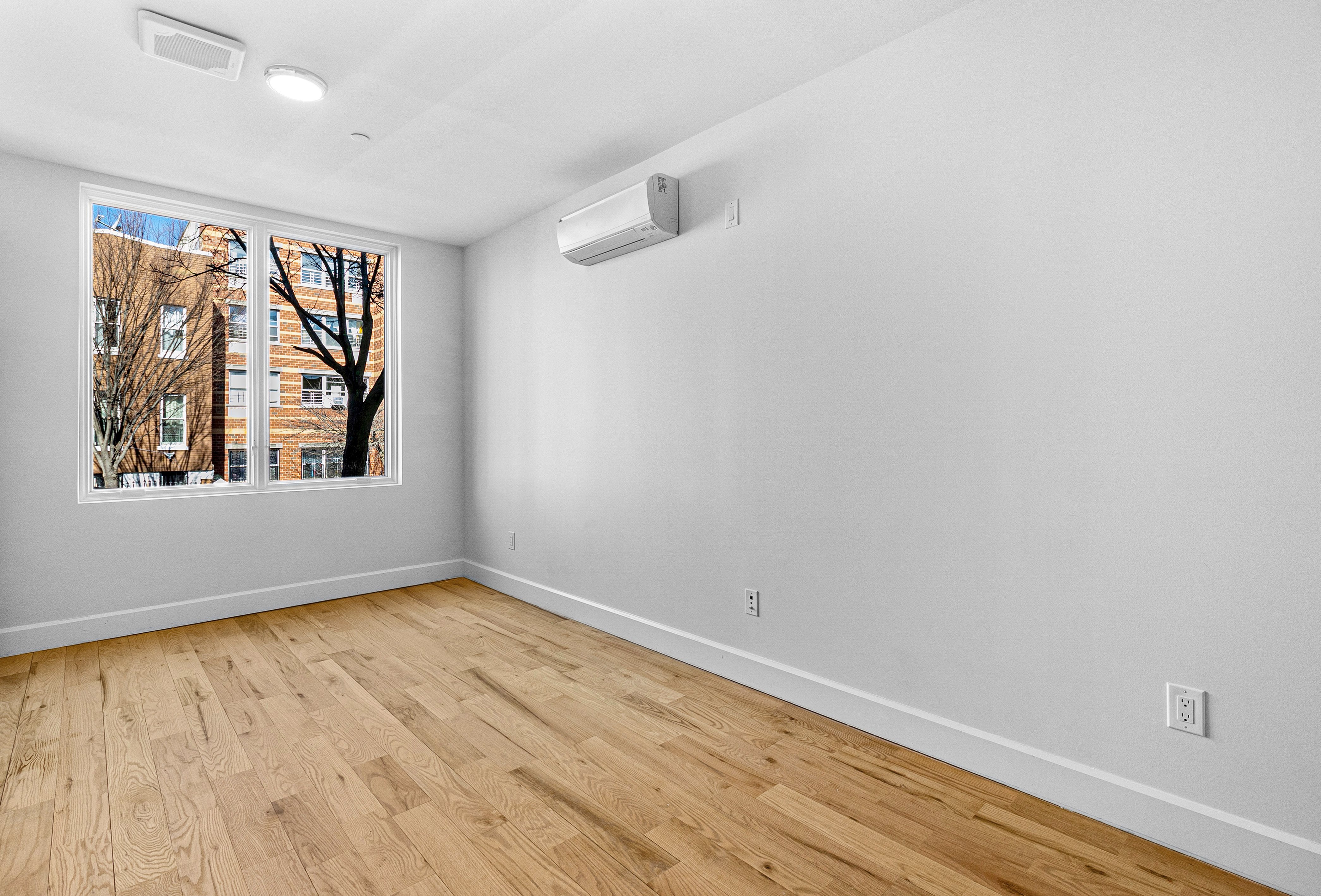1098 Madison Street, Unit 1A Brooklyn, NY 11221 - Photo 3 of 15 wooden floor in an empty room with a window