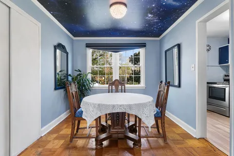 a view of a dining room with furniture window and wooden floor