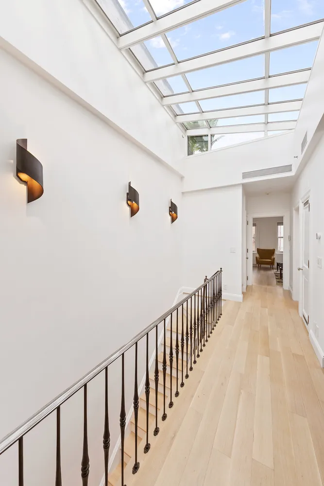 a view of hallway with wooden floor