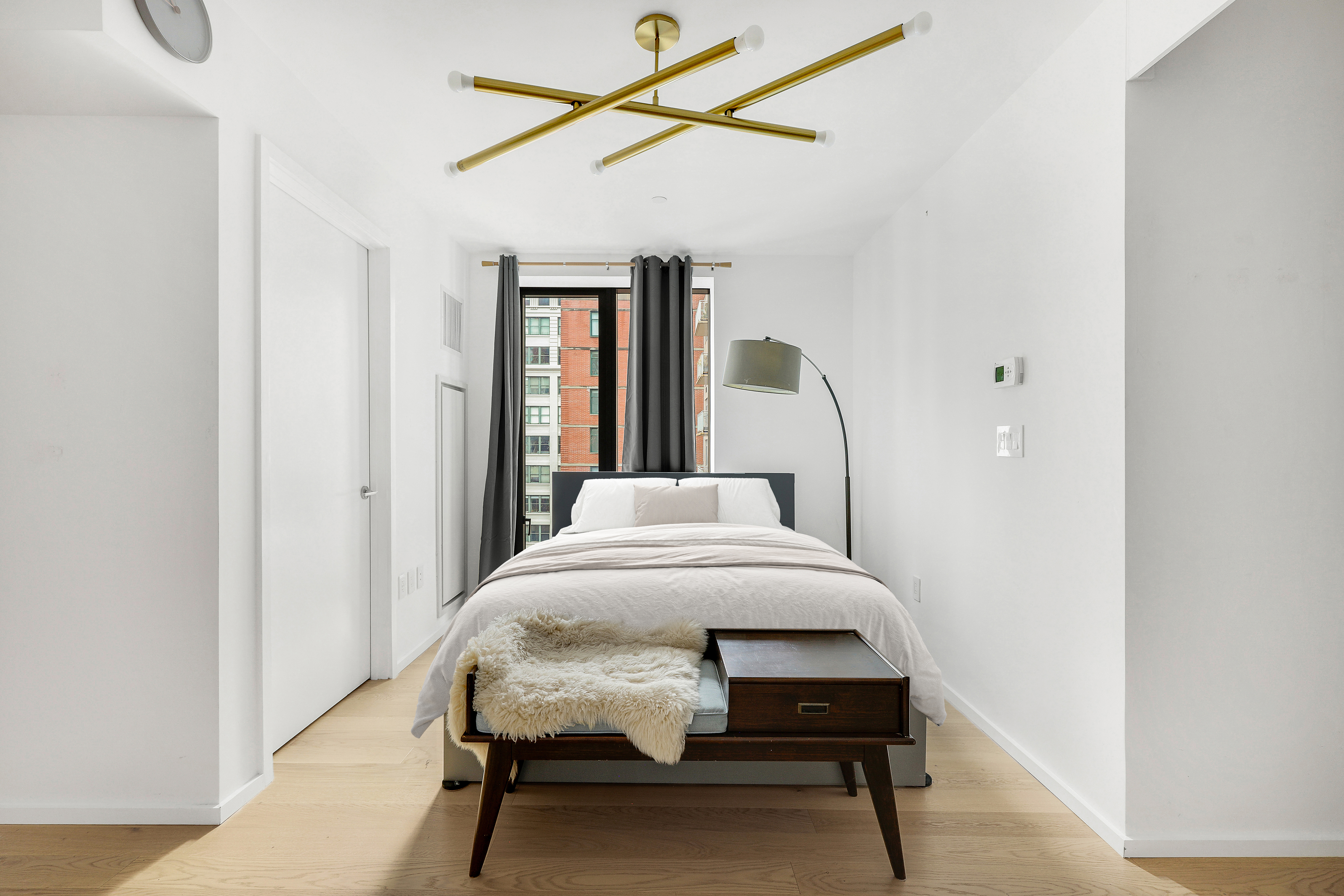 98 Front Street, Unit 9A Brooklyn, NY 11201 - Photo 6 of 31 a bedroom with a bed window and chair