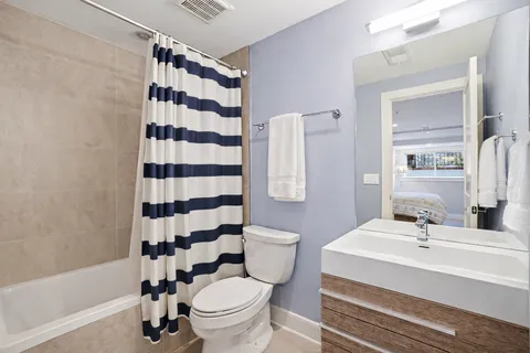 a bathroom with a sink toilet a mirror and shower