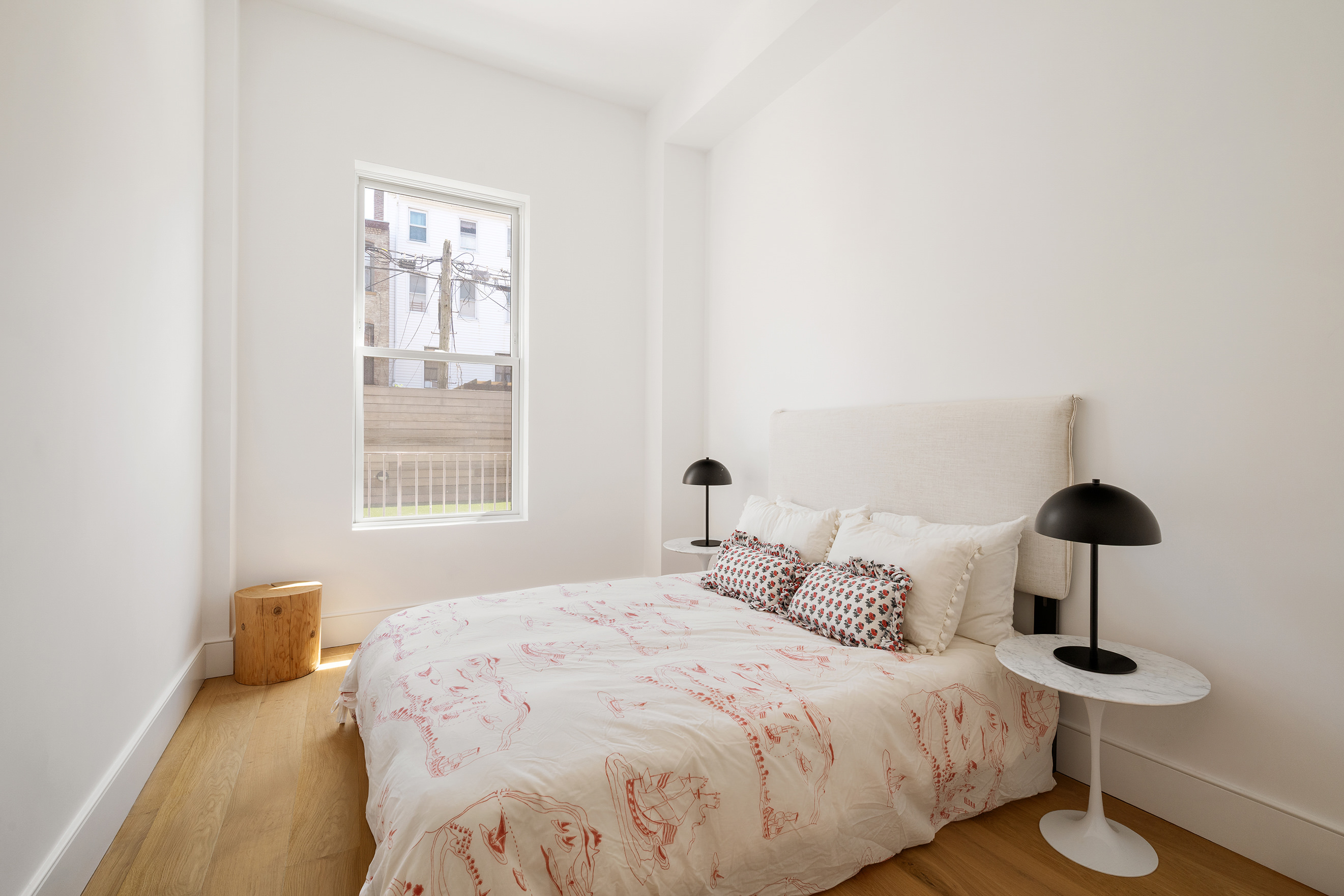 524 Halsey Street, Unit 109 Brooklyn, NY 11233 - Photo 6 of 10 a bedroom with a bed and a lamp