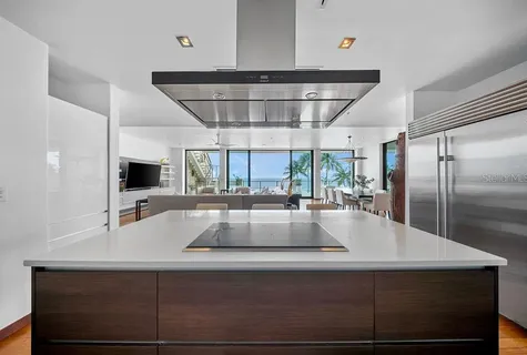 a view of kitchen with stainless steel appliances a sink and cabinets