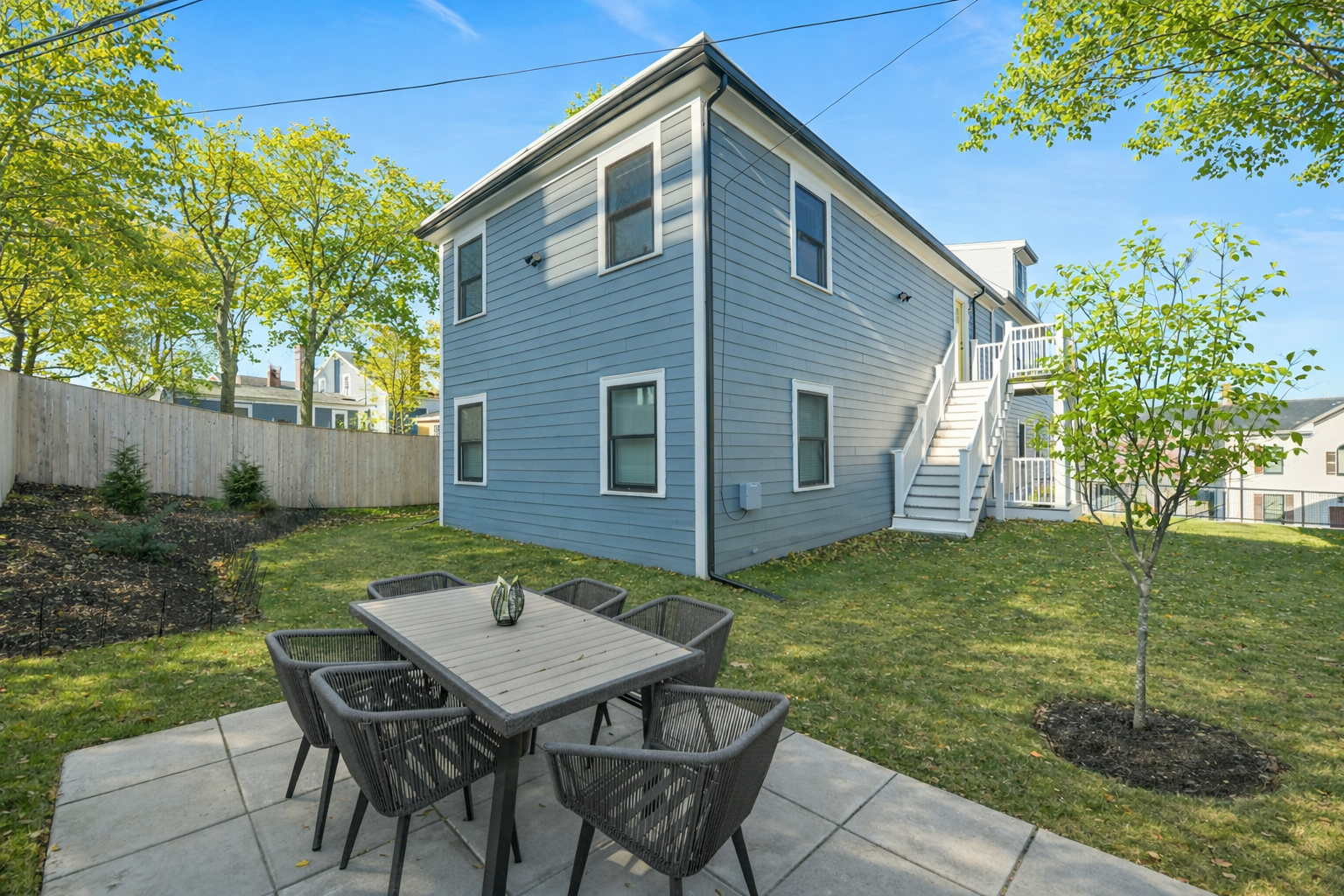17 Akron Street, Unit 2 Boston, MA 02119 - Photo 18 of 26 a backyard of a house with table and chairs