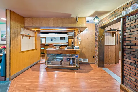 a living room with furniture pool table and rug floor