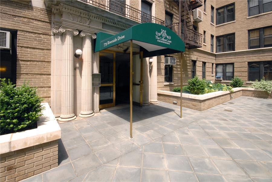 779 Riverside Drive, Unit B60 Manhattan, NY 10032 - Photo 6 of 9 a view of a chair and tables in the patio with a yard