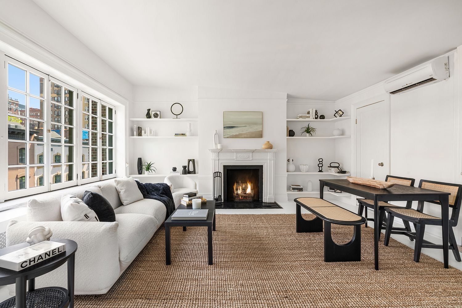 30-32 West 9th Street, Unit 5A Manhattan, NY 10011 - Photo 1 of 18 a living room with furniture a fireplace and a large window
