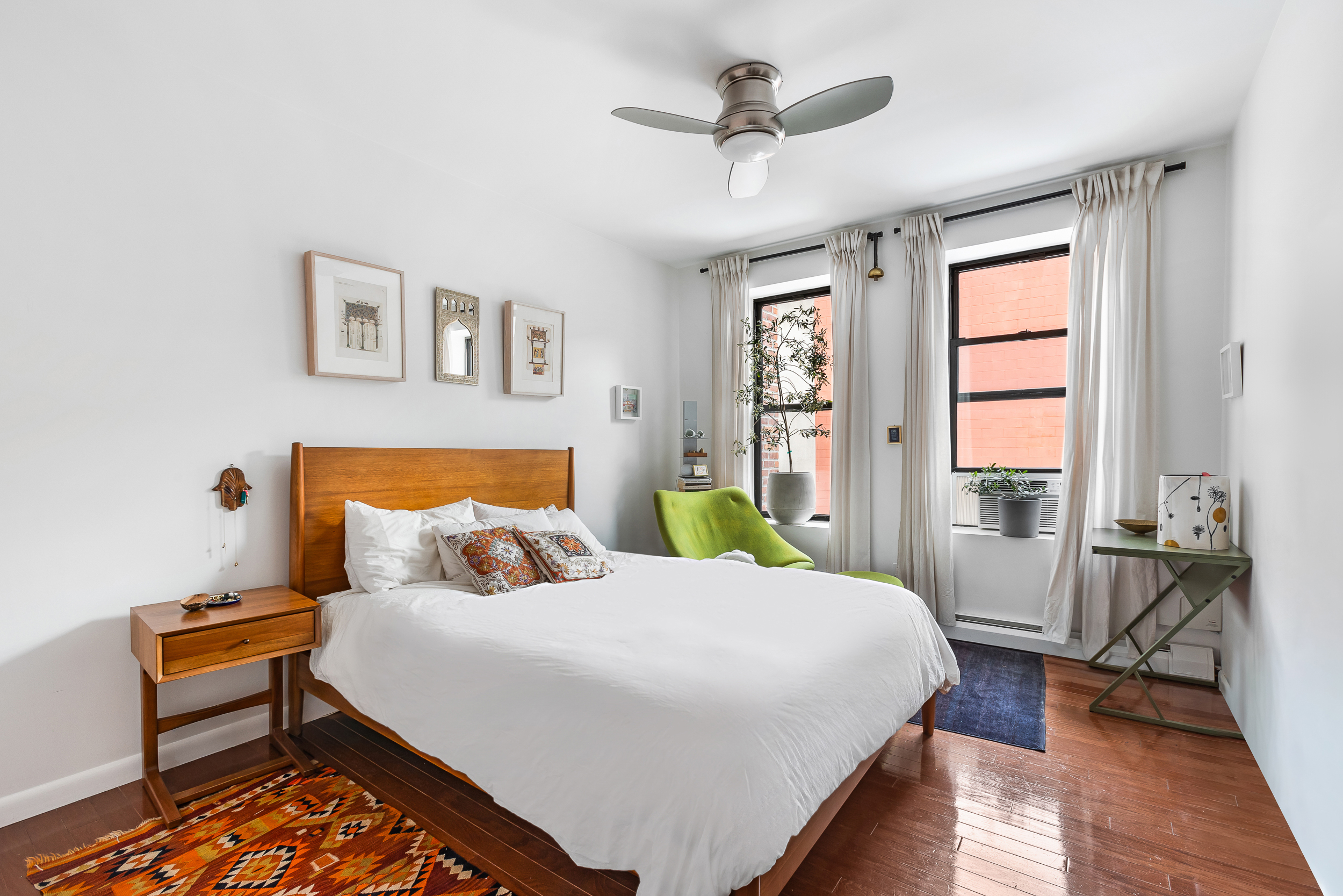 185 Smith Street Brooklyn, NY 11201 - Photo 8 of 14 a bedroom with a bed wooden floor and window