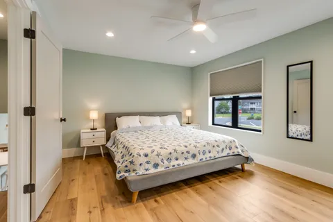 a bedroom with a large bed and a large window