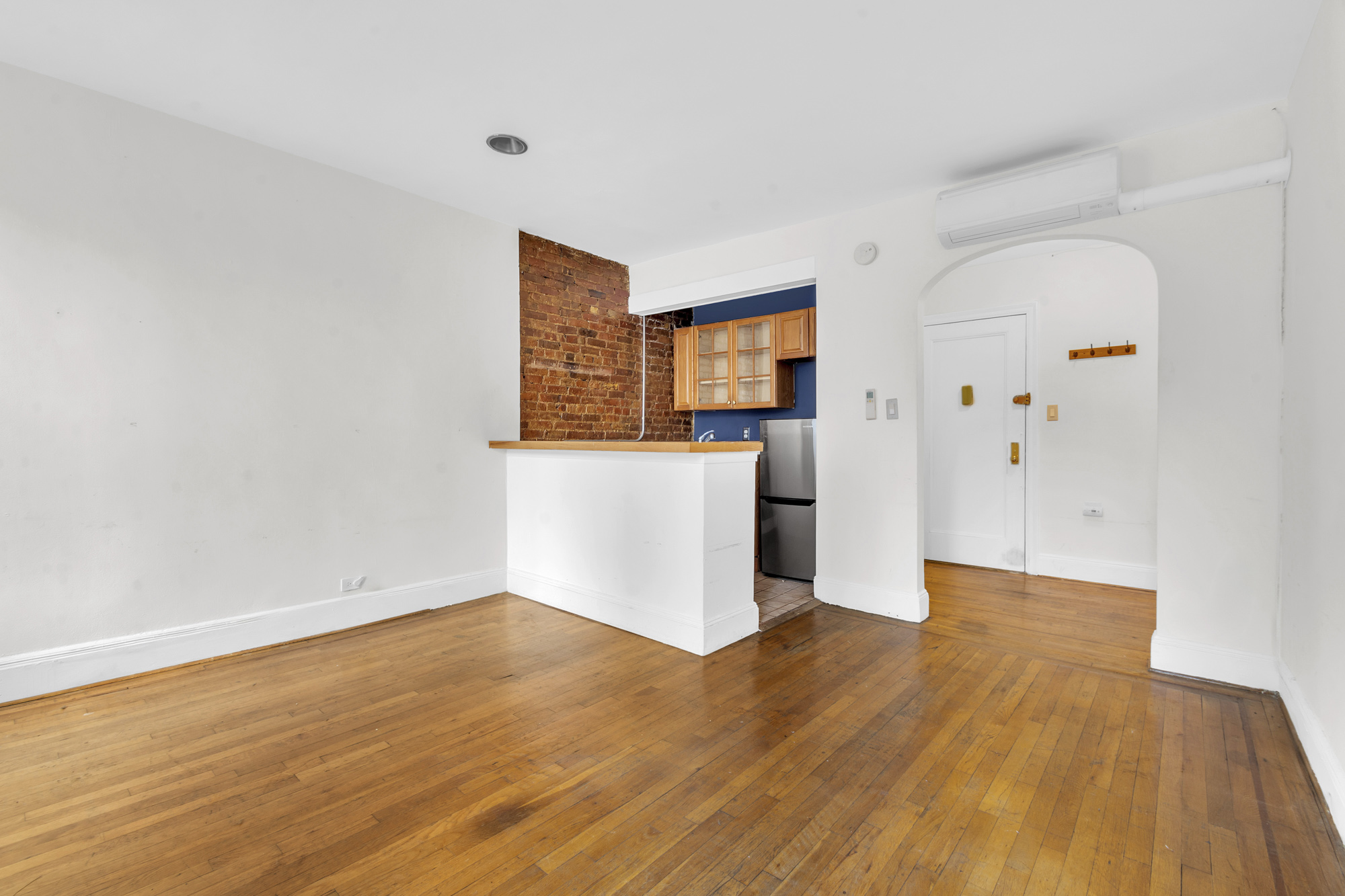 a view of a room with wooden floor and white doors