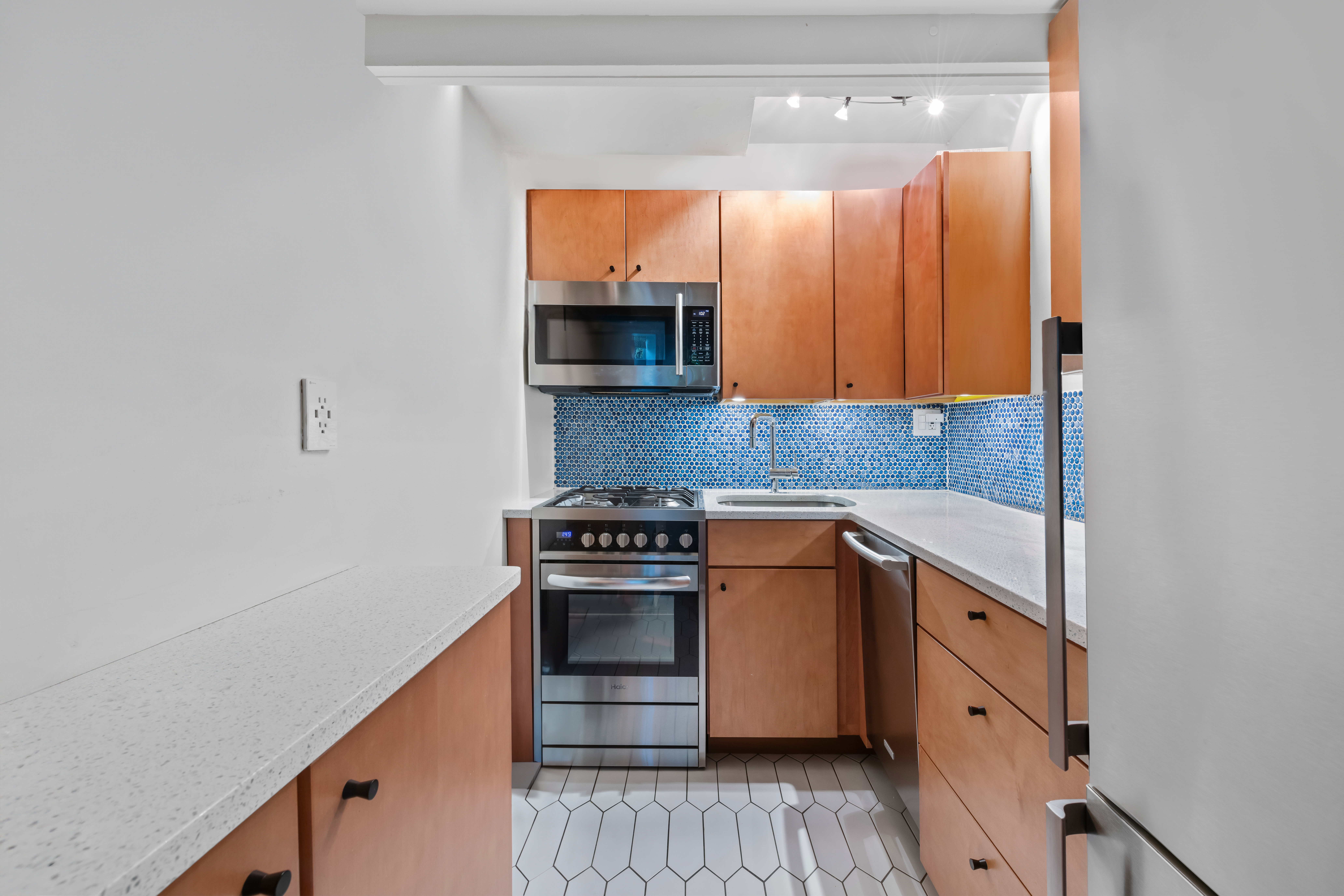 61 West 88th Street, Unit 1B/F Manhattan, NY 10024 - Photo 4 of 12 a kitchen with stainless steel appliances granite countertop a stove and a microwave