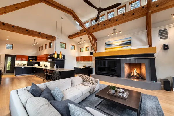 a living room with furniture a fireplace and a flat screen tv