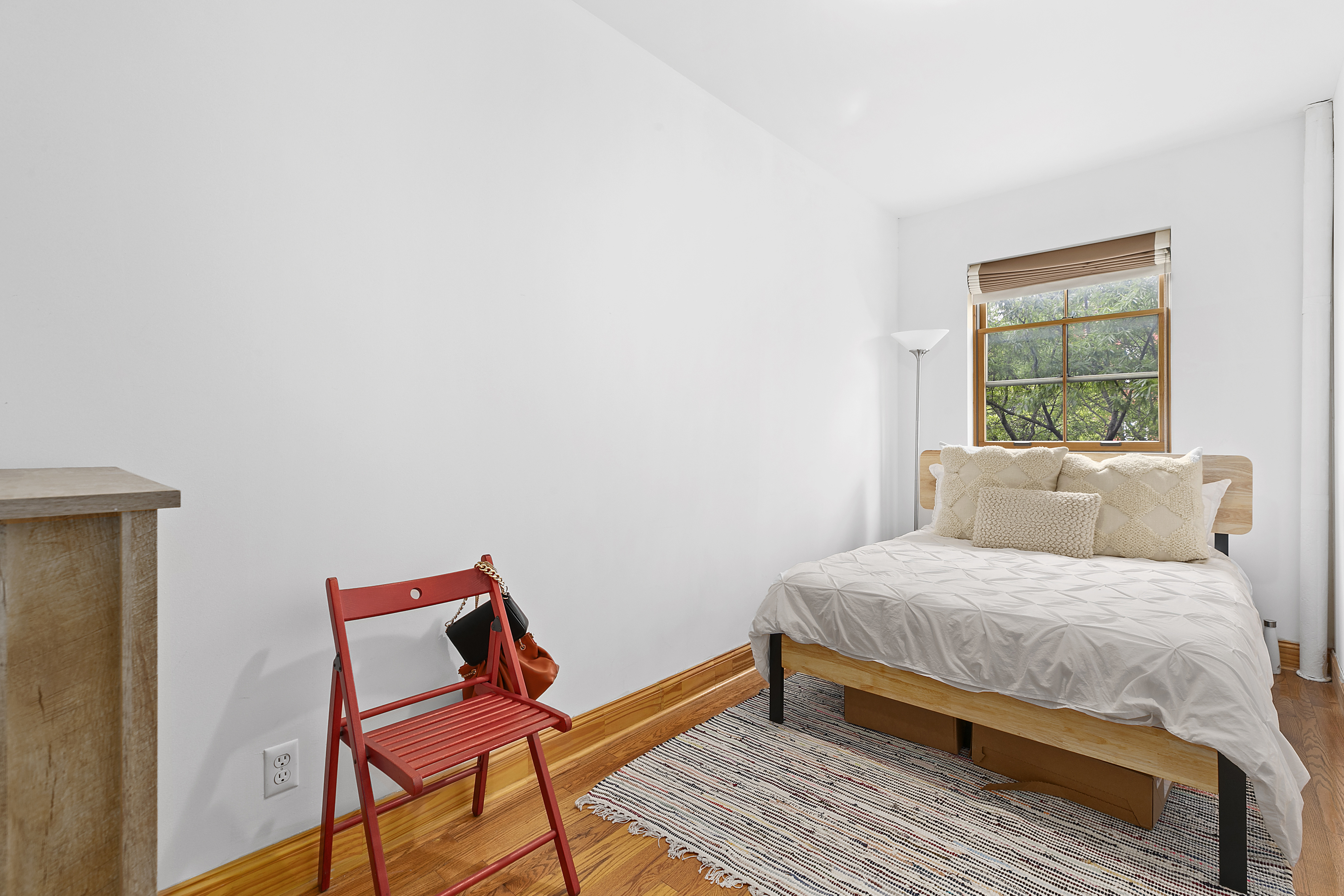 548 1/2 Hudson Street, Unit 2 Manhattan, NY 10014 - Photo 5 of 6 a bedroom with a bed and wooden floor