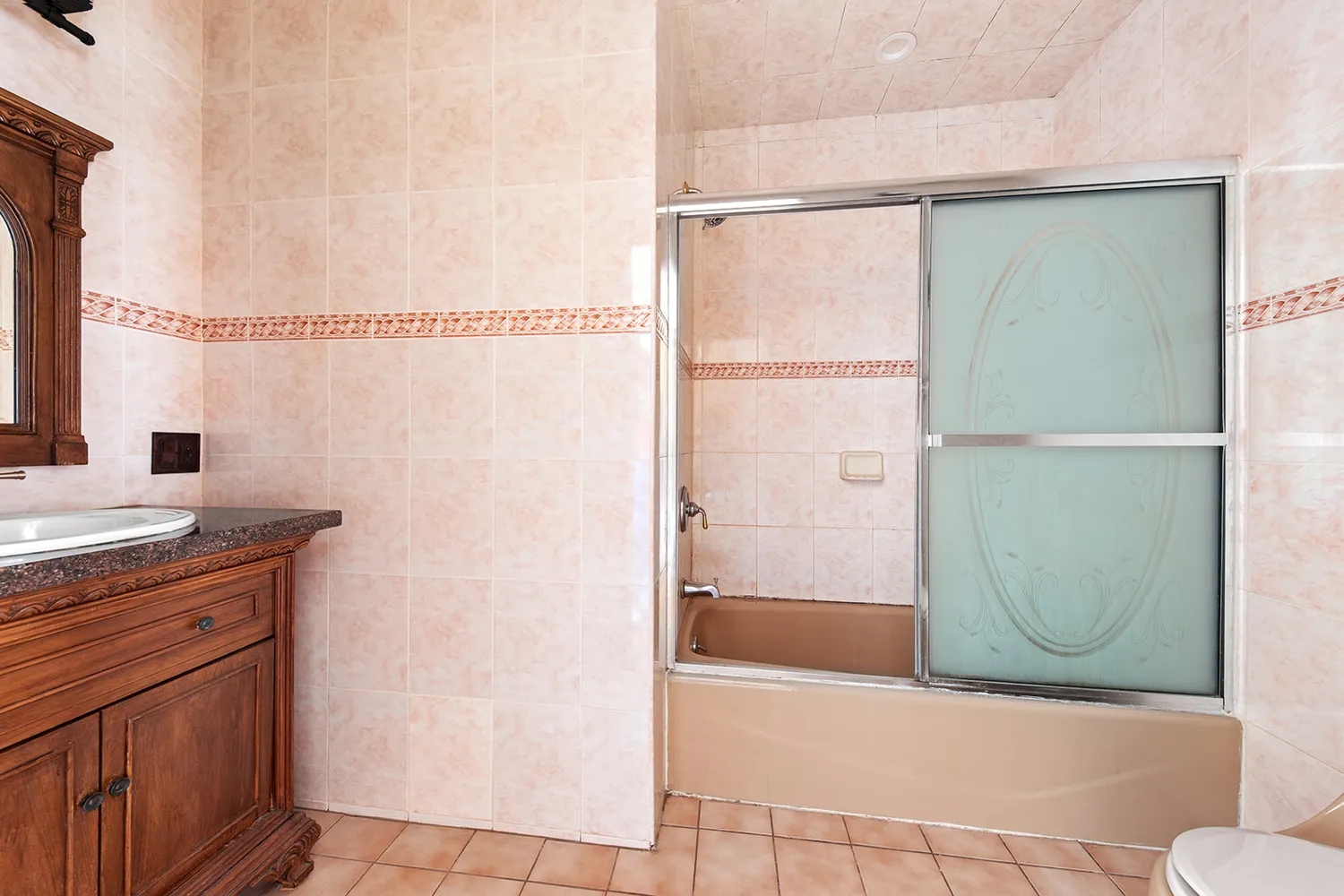 a bathroom with a granite countertop shower a mirror and a sink