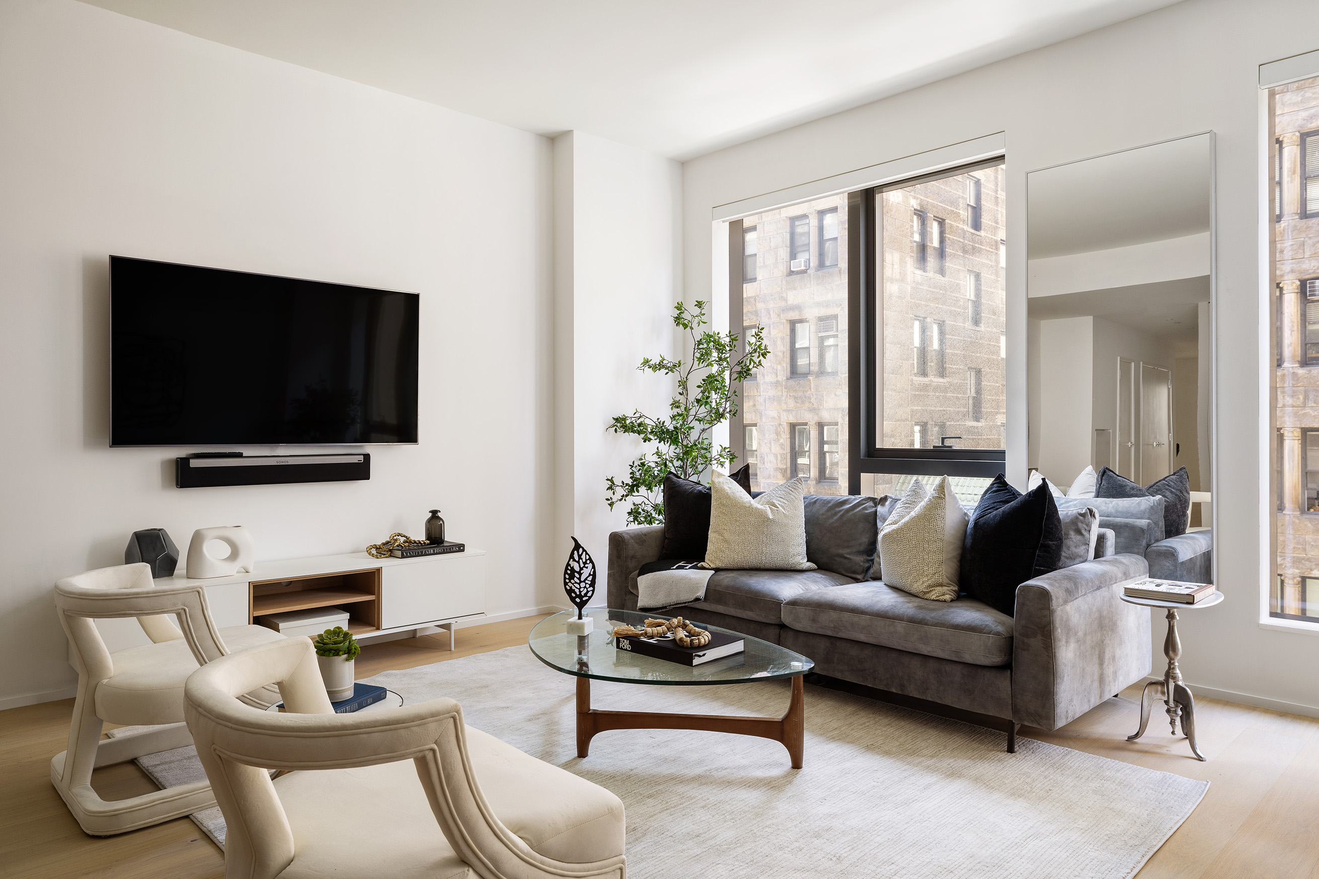 121 East 22nd Street, Unit S603 Manhattan, NY 10010 - Photo 2 of 12 a living room with furniture and a flat screen tv