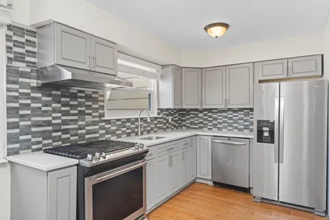 a kitchen with stainless steel appliances granite countertop a stove and a refrigerator