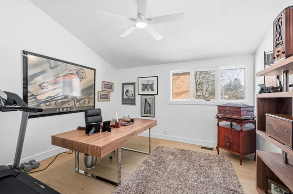 a living room with couch and painting on the wall