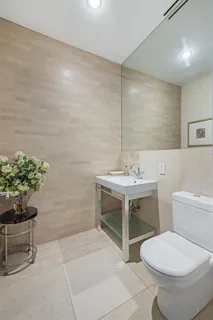 a bathroom with a sink toilet and a mirror