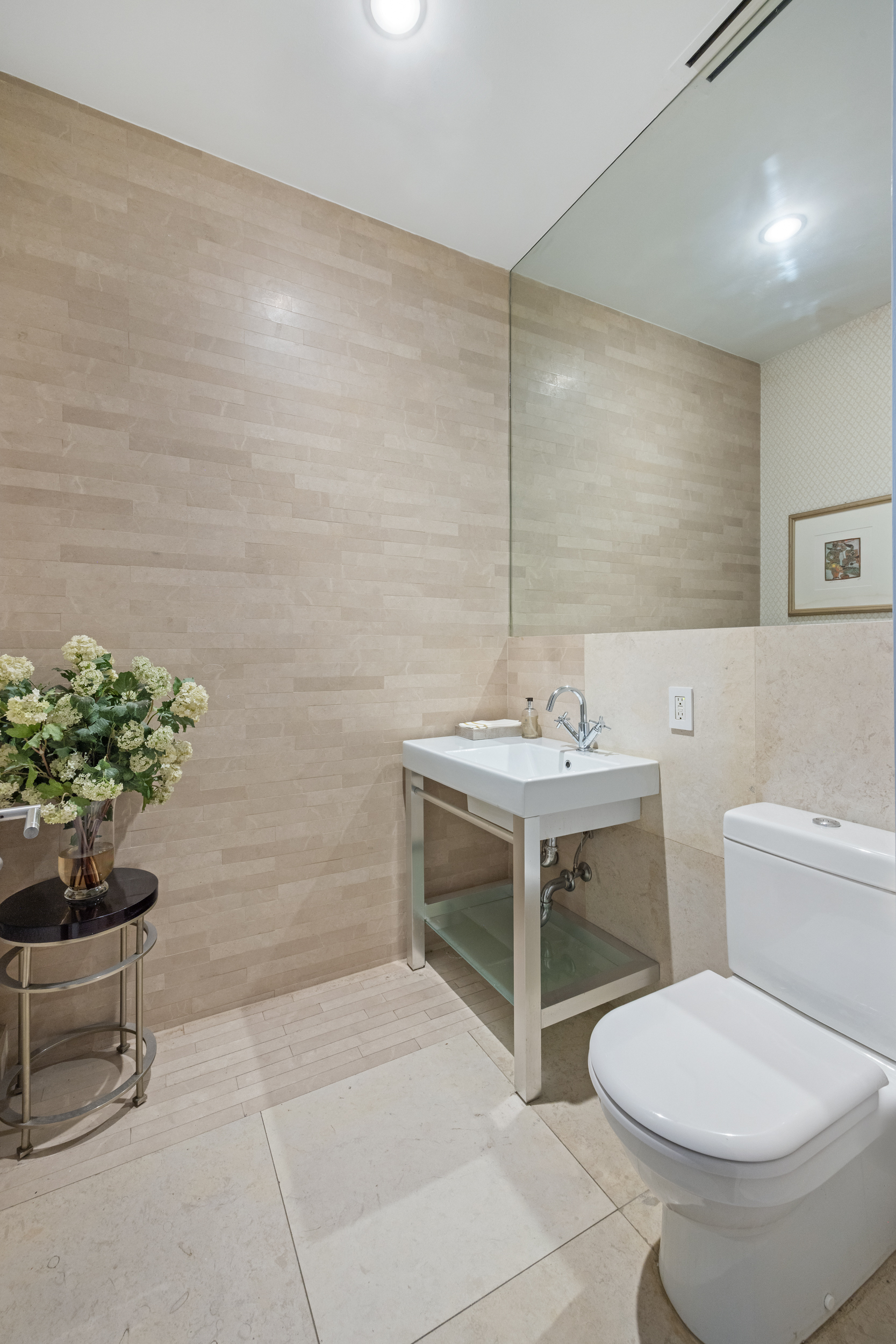 157 East 84th Street, Unit THA Manhattan, NY 10028 - Photo 16 of 33 a bathroom with a sink toilet and a mirror