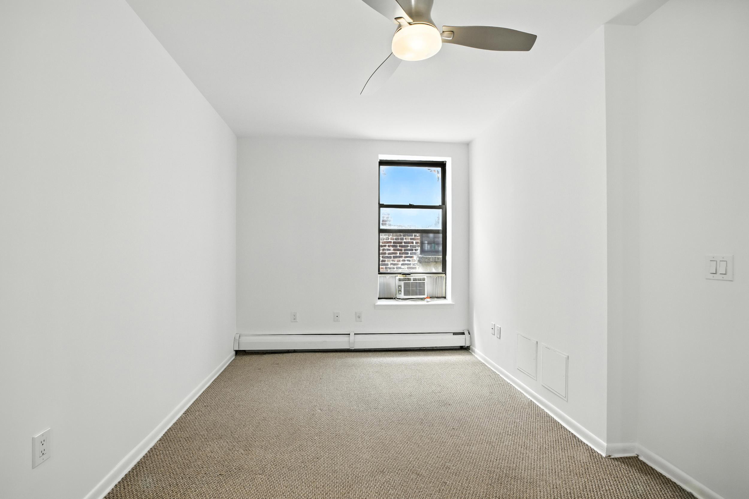 2611 Frederick Douglass Boulevard, Unit 4A Manhattan, NY 10030 - Photo 6 of 10 an empty room with a window