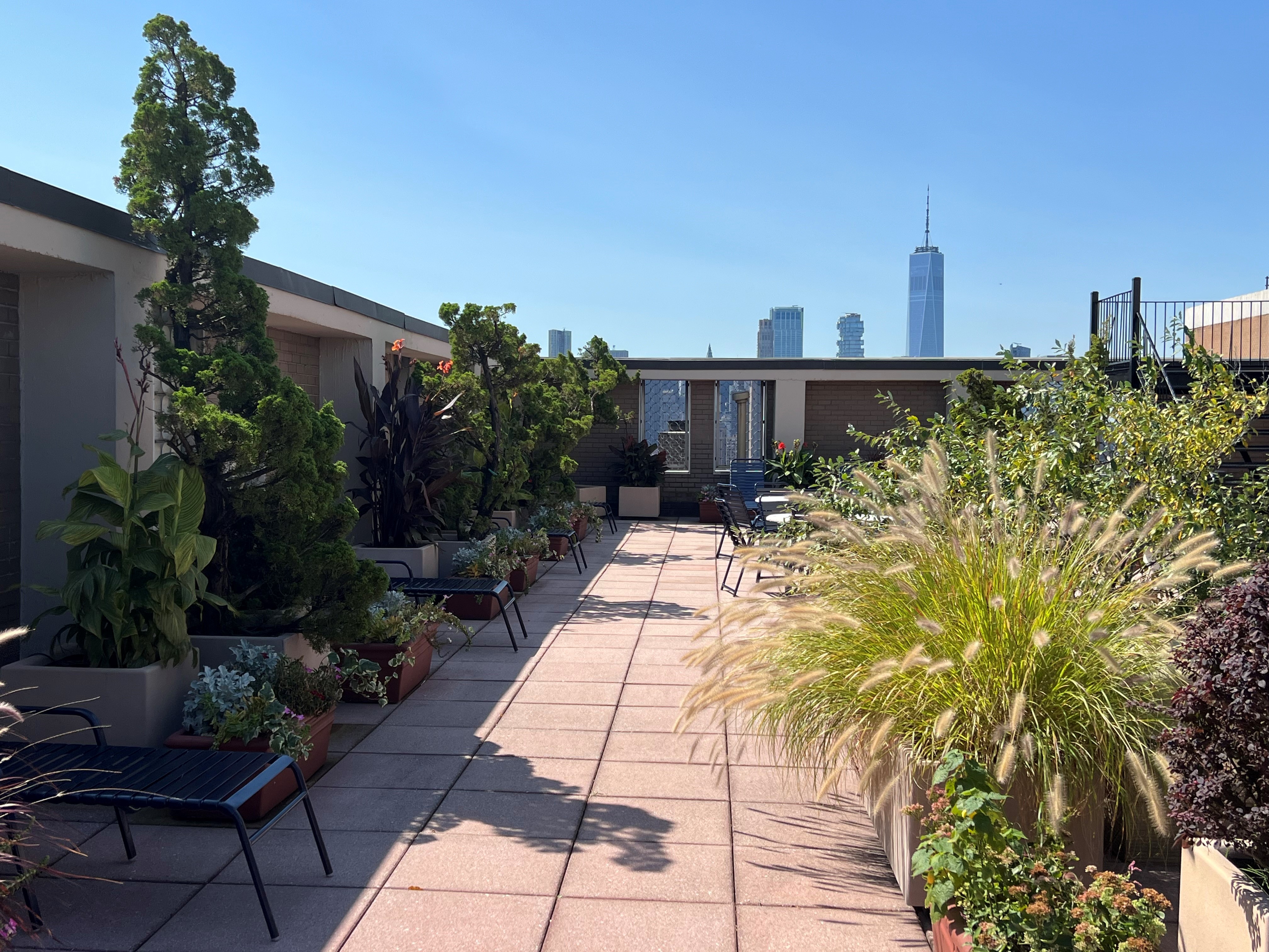 60 East 8th Street, Unit 23D Manhattan, NY 10003 - Photo 12 of 16 a view of a pathway with a bench in front of house
