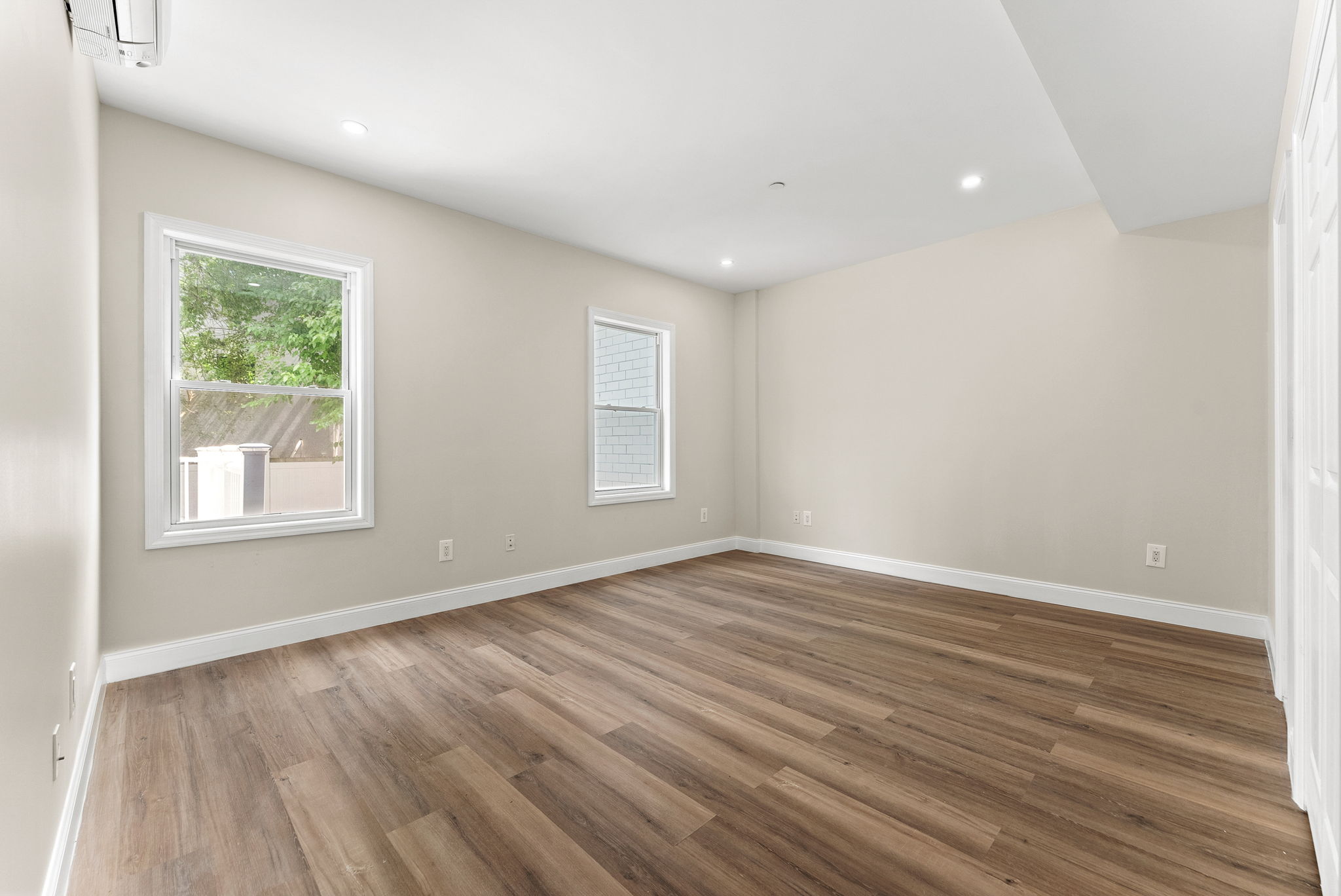 217 Butler Street, Unit 1 Brooklyn, NY 11217 - Photo 4 of 10 an empty room with wooden floor and windows