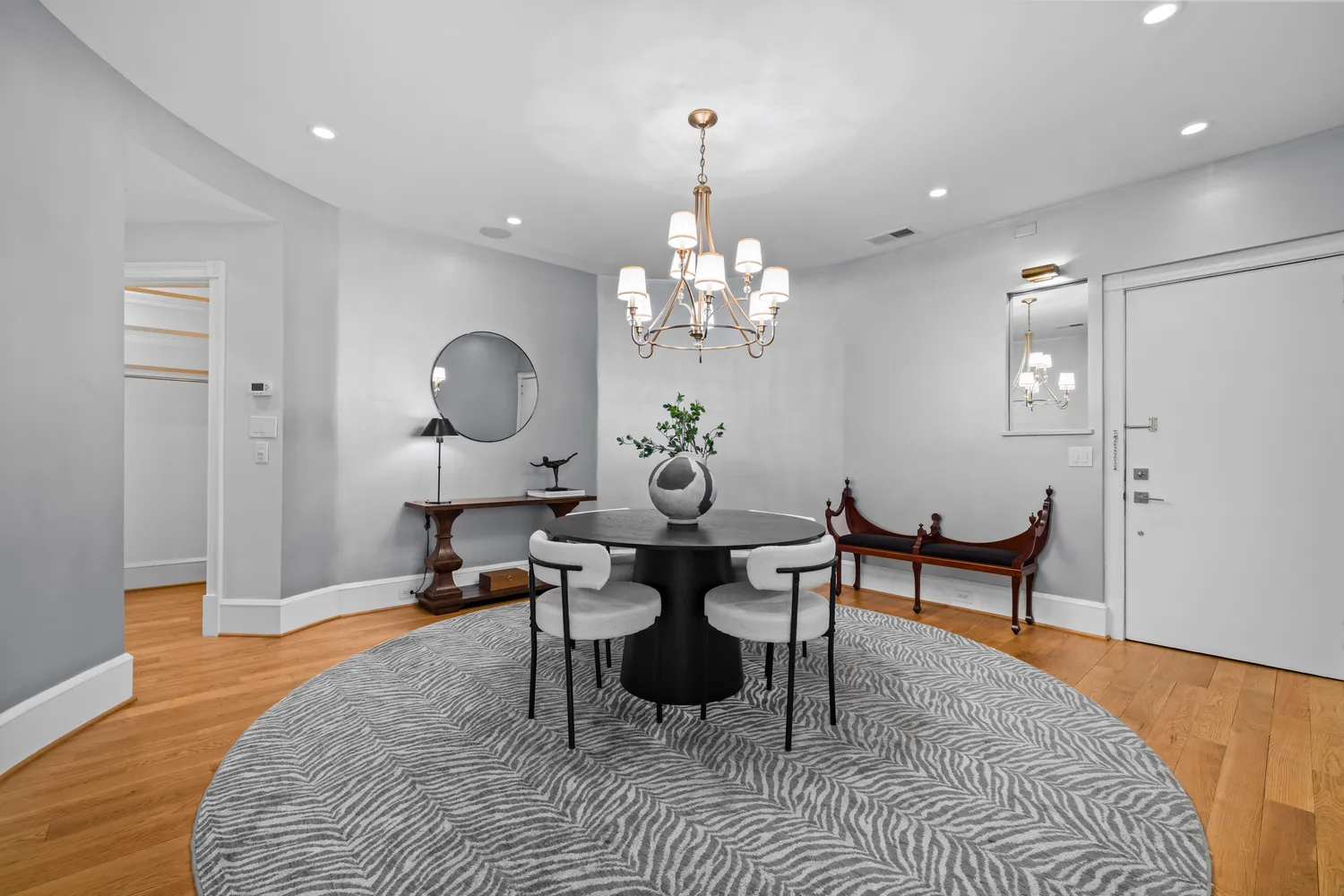 a living room with furniture a chandelier and a rug