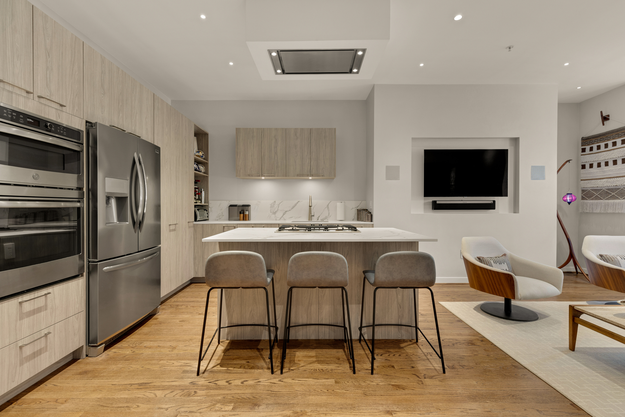 1407 15th Street Northwest, Unit 2 Washington, DC 20005 - Photo 4 of 24 a kitchen with stainless steel appliances granite countertop a stove a sink a microwave a refrigerator and chairs