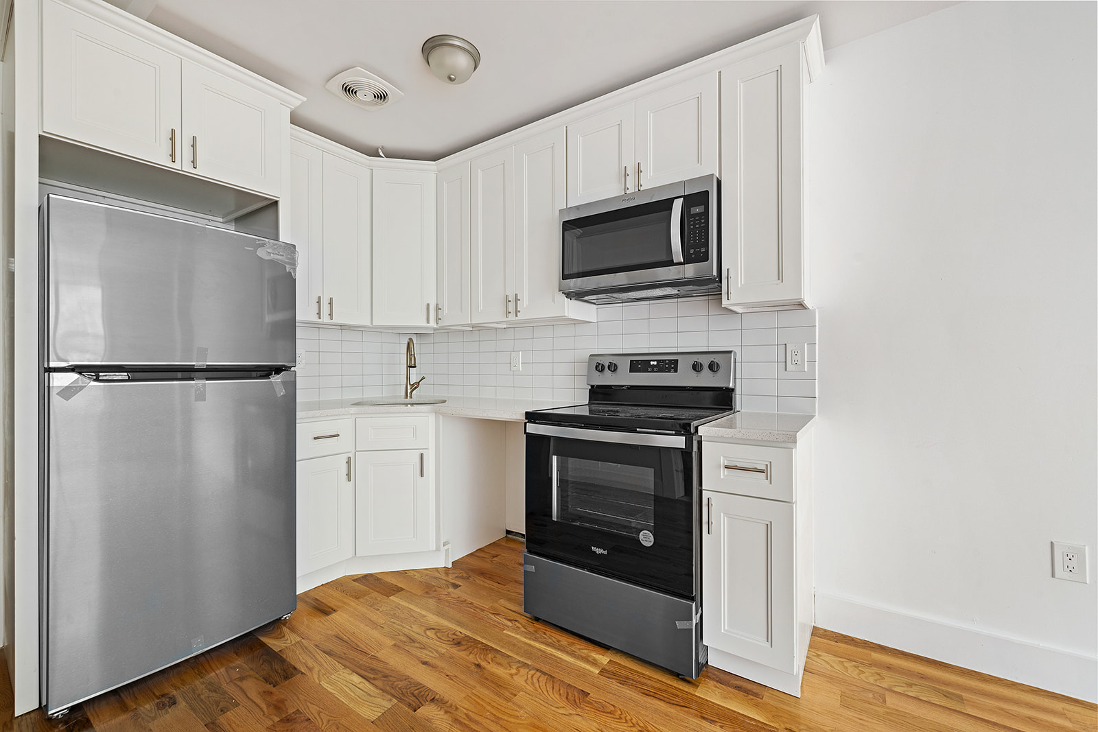 422 East 31st Street Brooklyn, NY 11226 - Photo 7 of 16 a kitchen with stainless steel appliances a refrigerator stove and microwave
