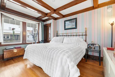 a bedroom with a bed and a large window