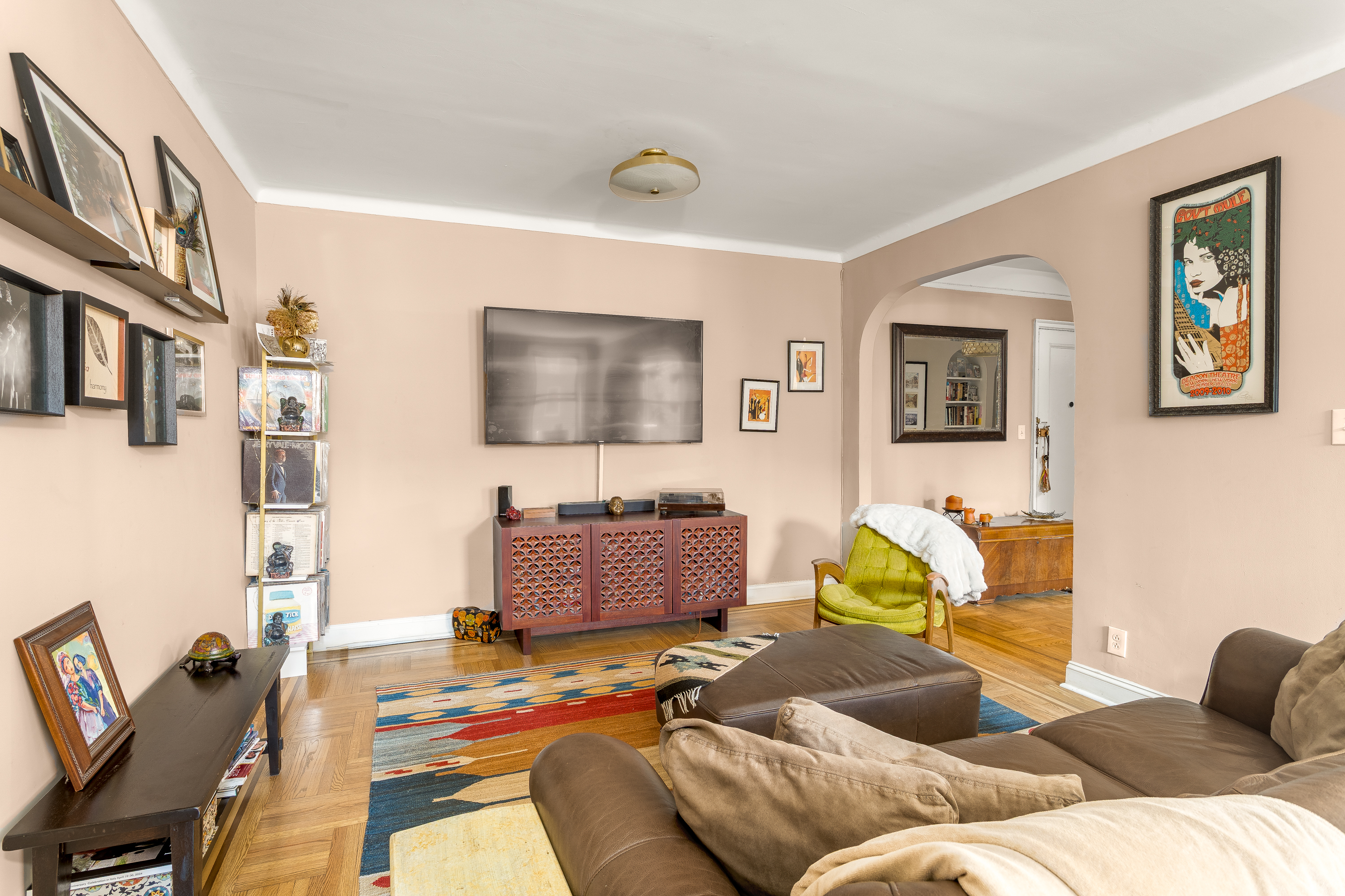 35-06 88th Street, Unit 5DD Queens, NY 11372 - Photo 4 of 18 a living room with furniture and a flat screen tv