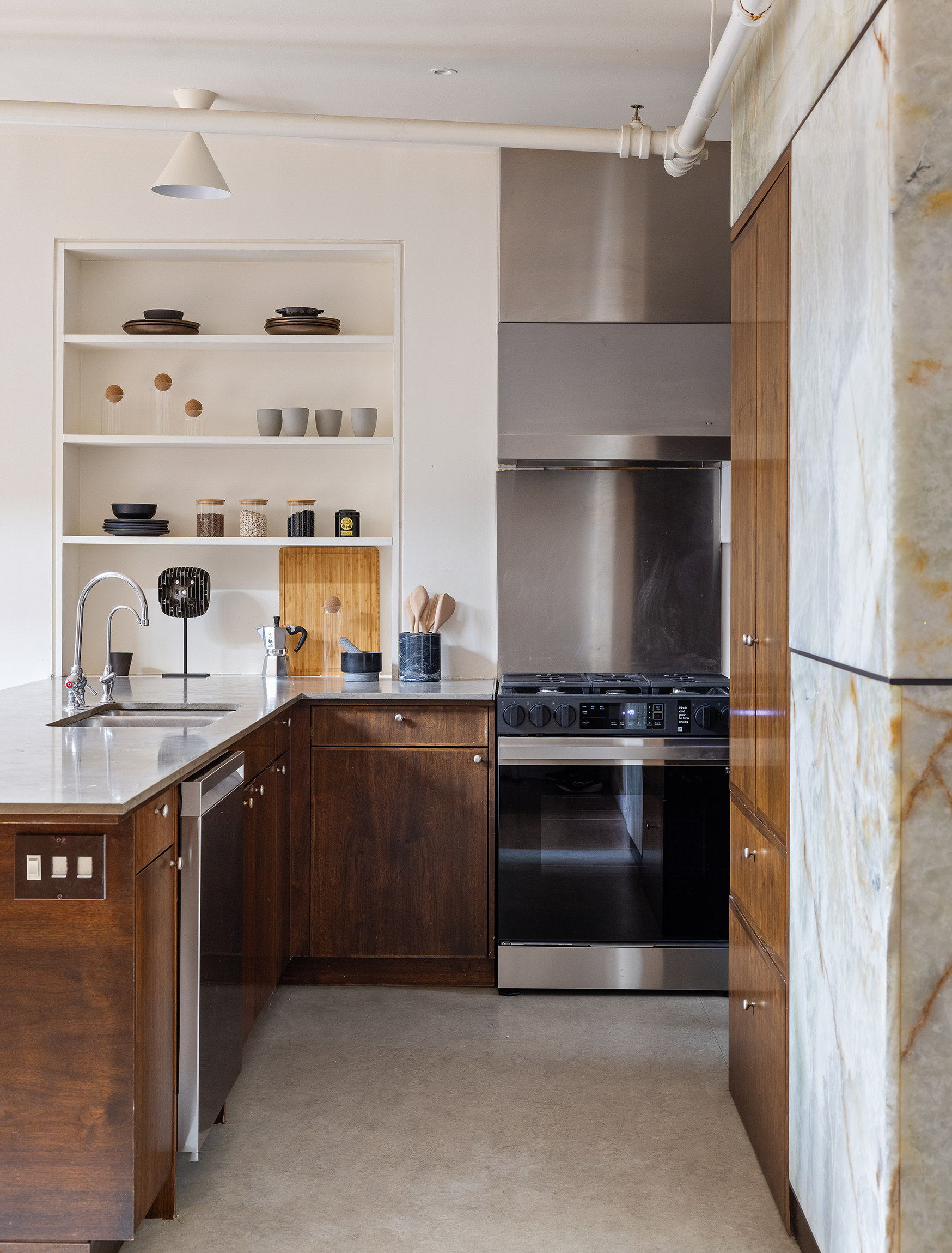 169 Mercer Street, Unit PH Manhattan, NY 10012 - Photo 7 of 15 a kitchen with stainless steel appliances granite countertop a stove and a refrigerator