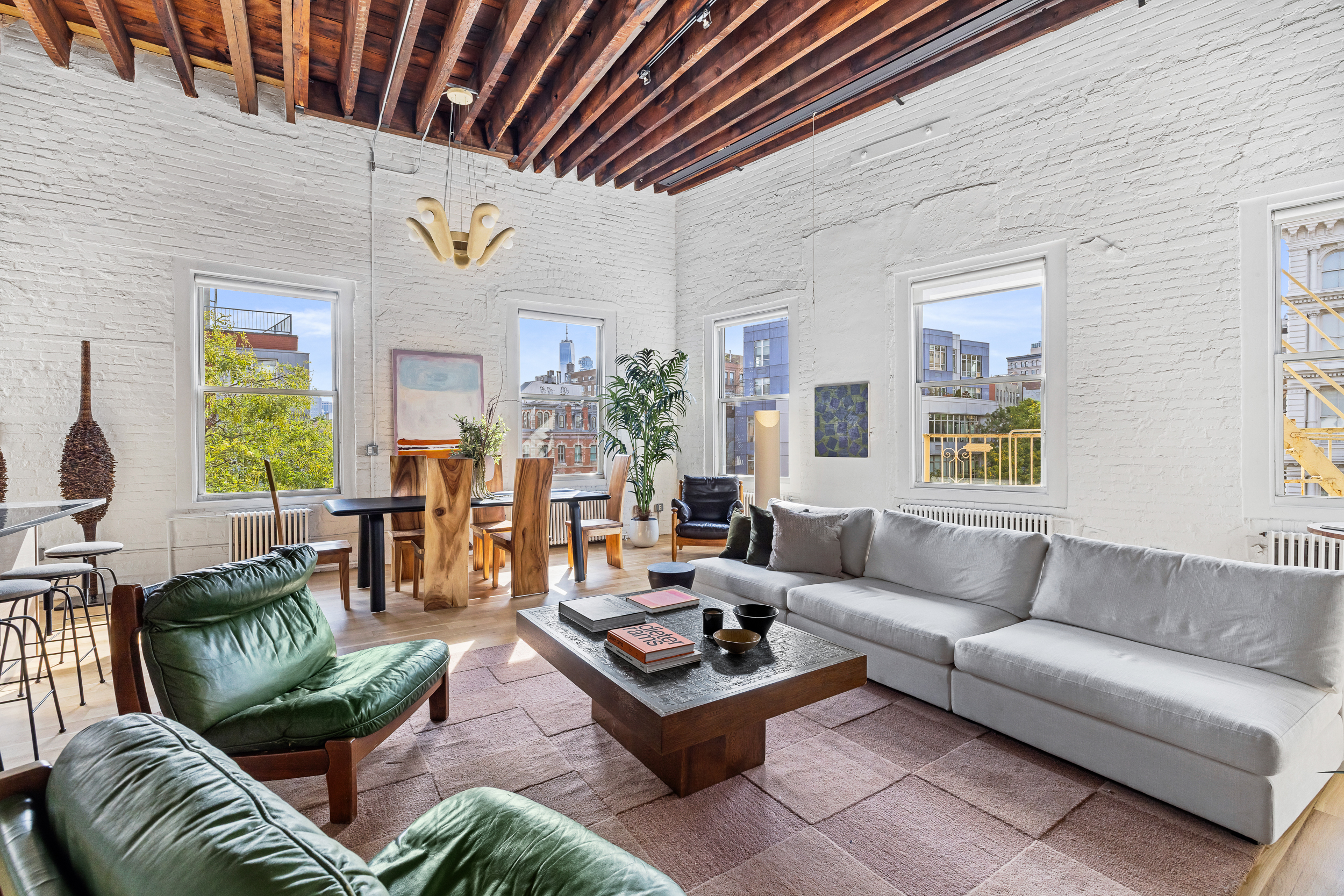 325 Bowery, Unit PH Manhattan, NY 10003 - Photo 4 of 17 a living room with furniture and a large window