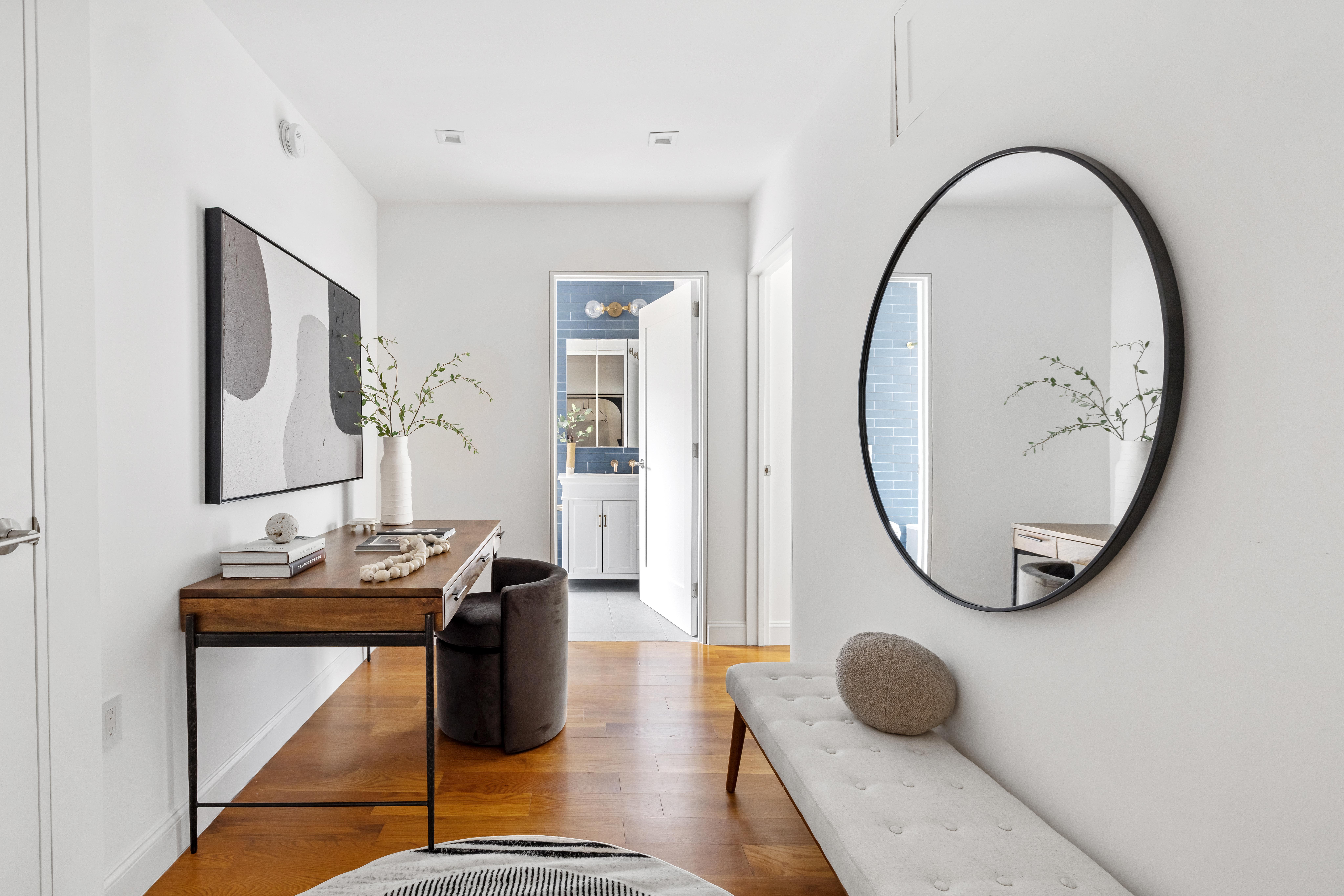 328 West 96th Street, Unit 2C Manhattan, NY 10025 - Photo 10 of 15 a room with wooden floor and a mirror