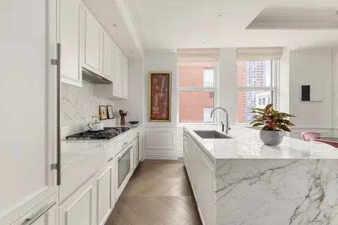 a kitchen with stainless steel appliances a sink stove and cabinets