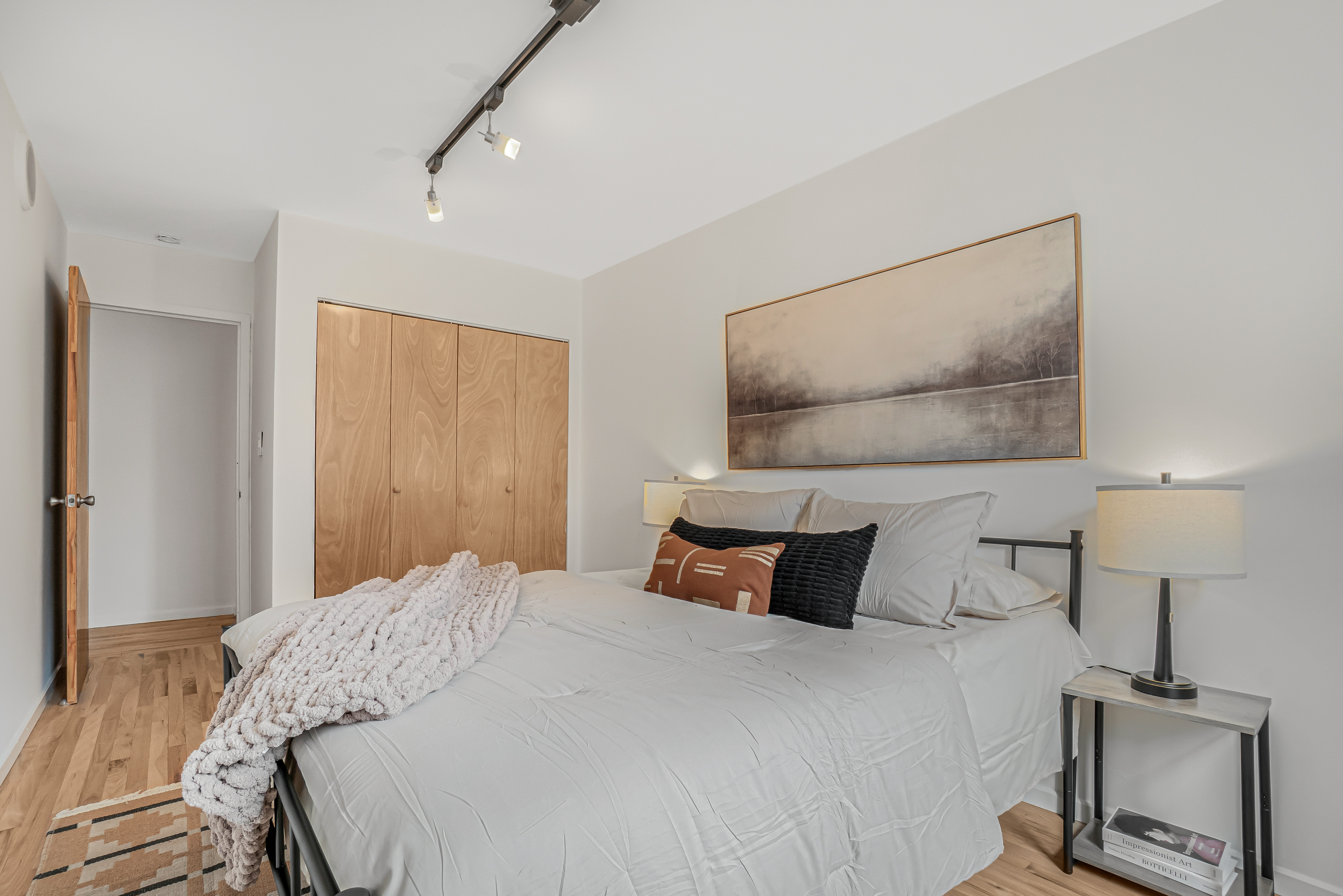 7 Gates Avenue, Unit H Brooklyn, NY 11238 - Photo 9 of 20 a bedroom with a bed and a lamp