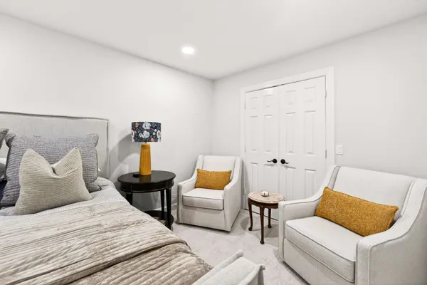 a bedroom with a bed and a couch