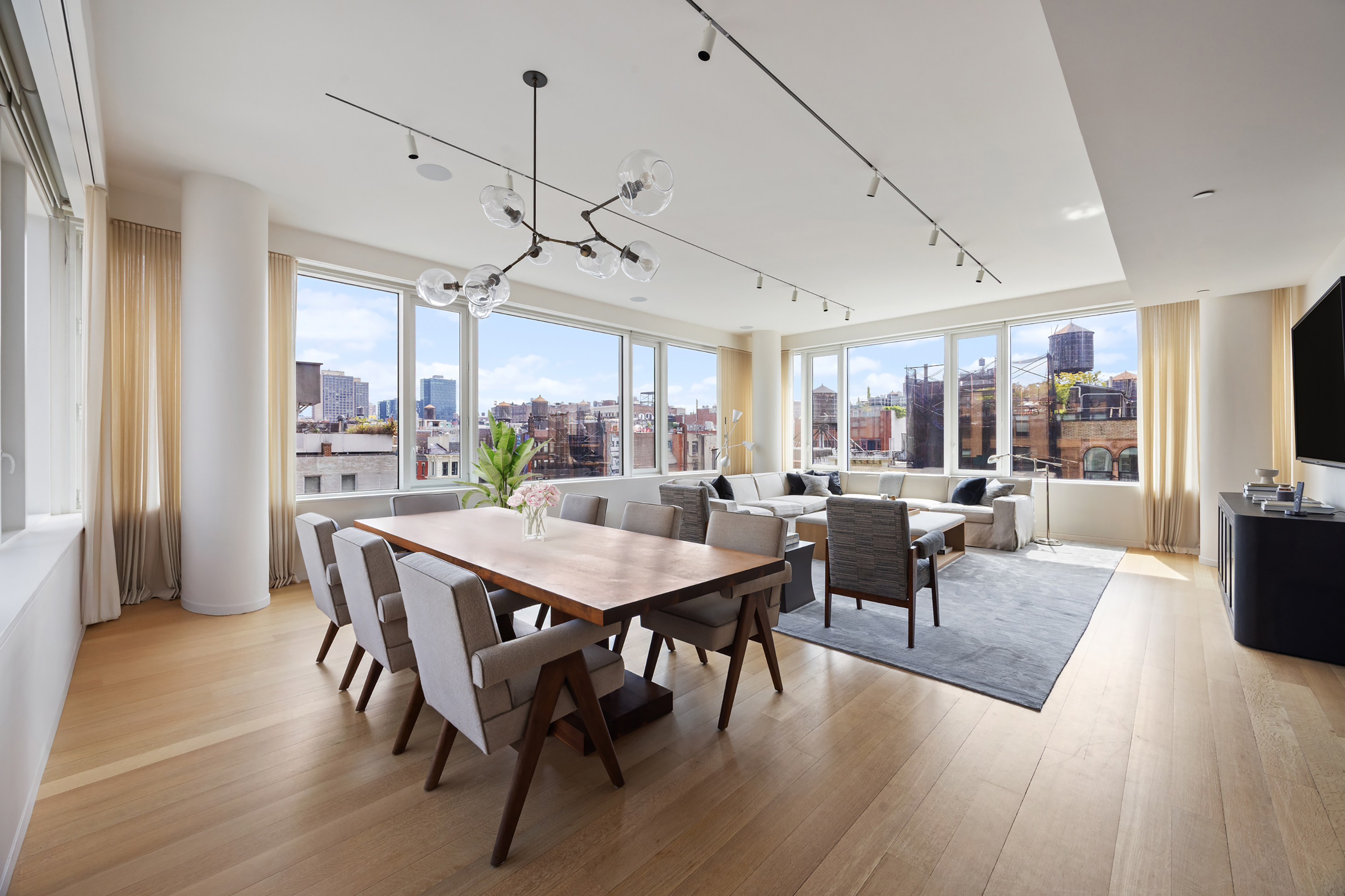 350 West Broadway, Unit 7FL Manhattan, NY 10013 - Photo 2 of 17 a view of a dining room with furniture window and wooden floor