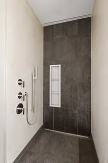 a bedroom with a large bed and a night stand