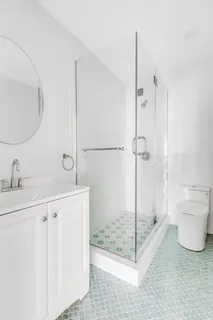 a bathroom with a shower sink and toilet