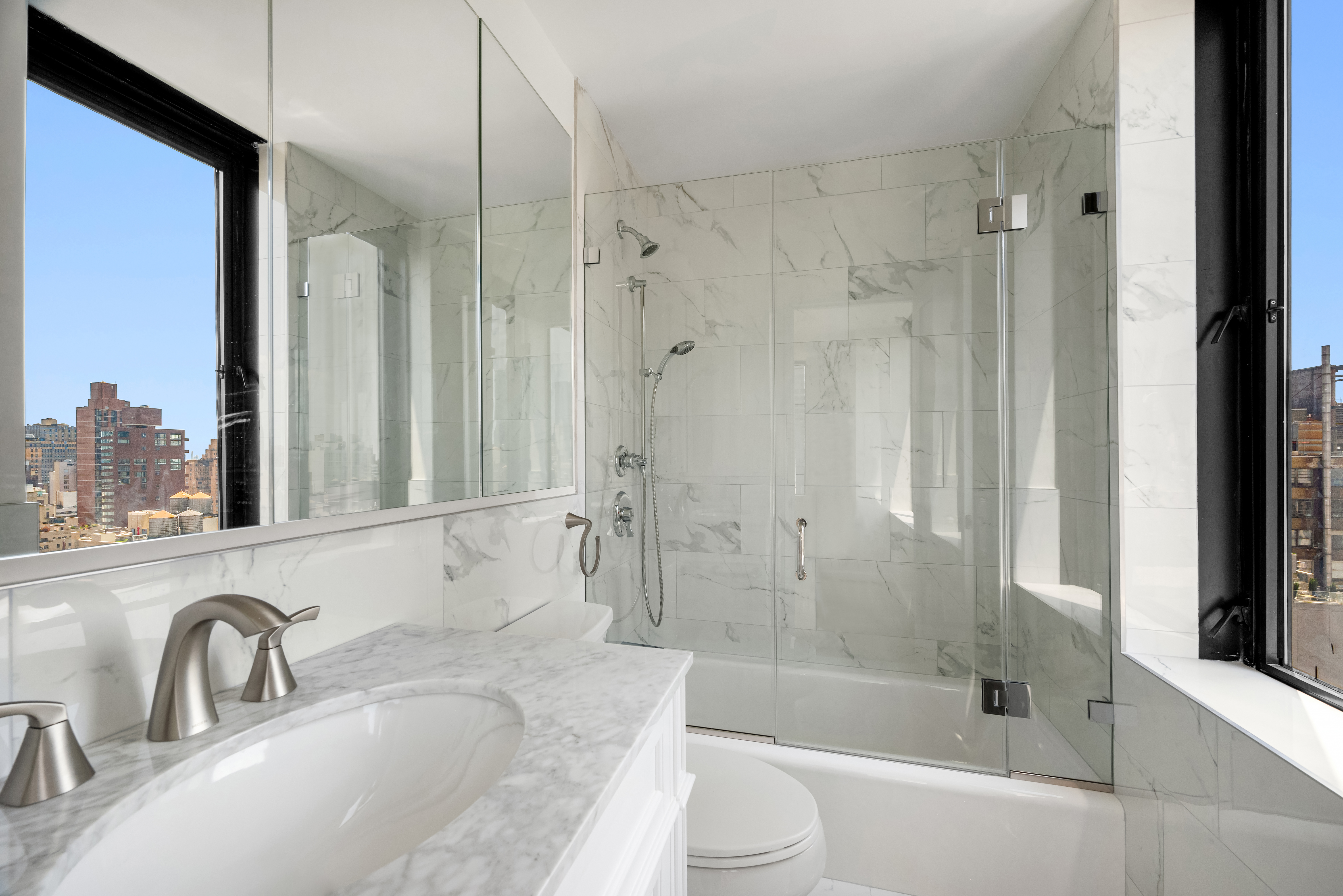 445 5th Avenue, Unit 26C Manhattan, NY 10016 - Photo 5 of 11 a bathroom with a granite countertop sink toilet and shower