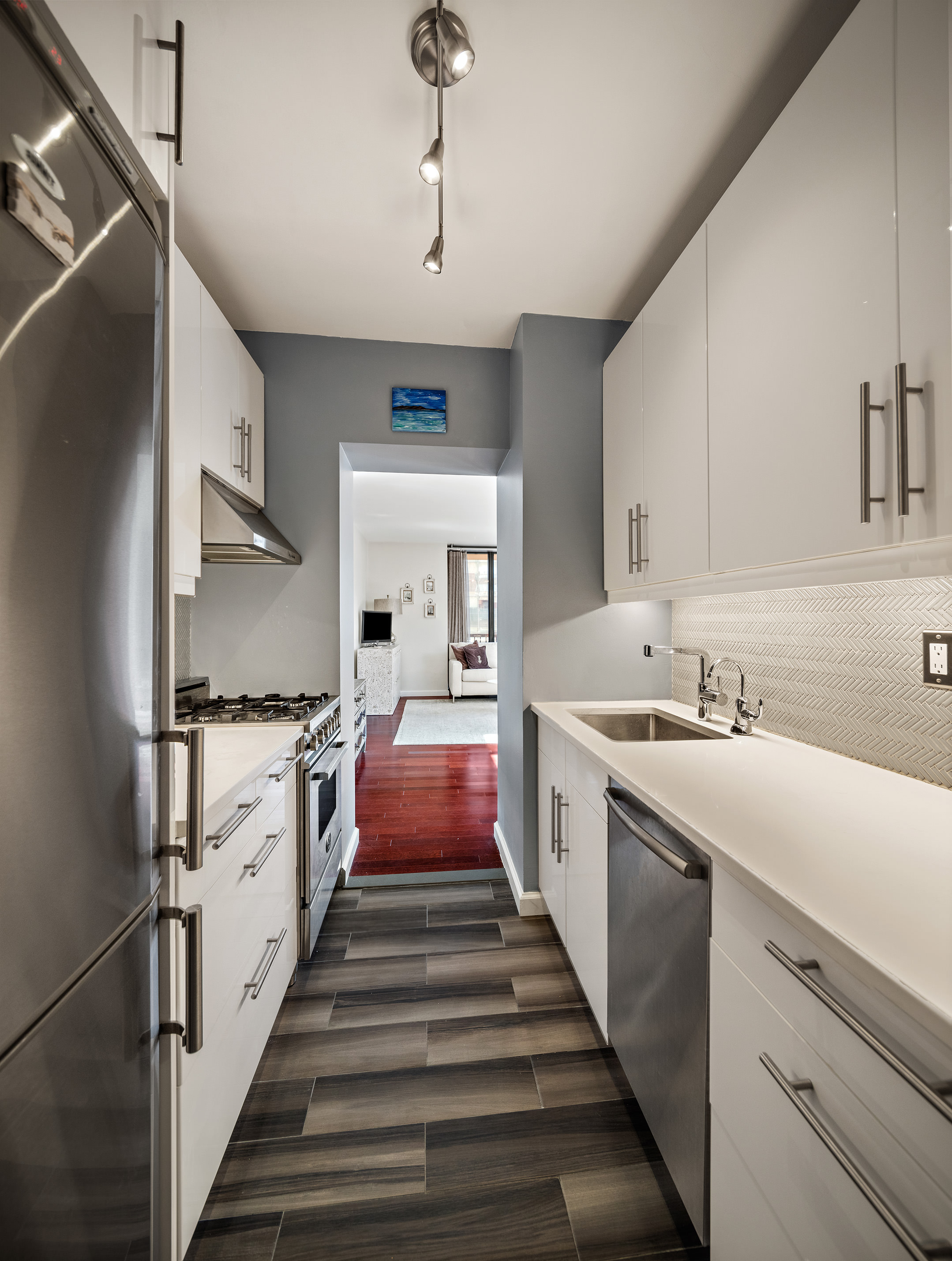 304 East 65th Street, Unit 10D Manhattan, NY 10065 - Photo 7 of 14 a kitchen with sink stove and refrigerator
