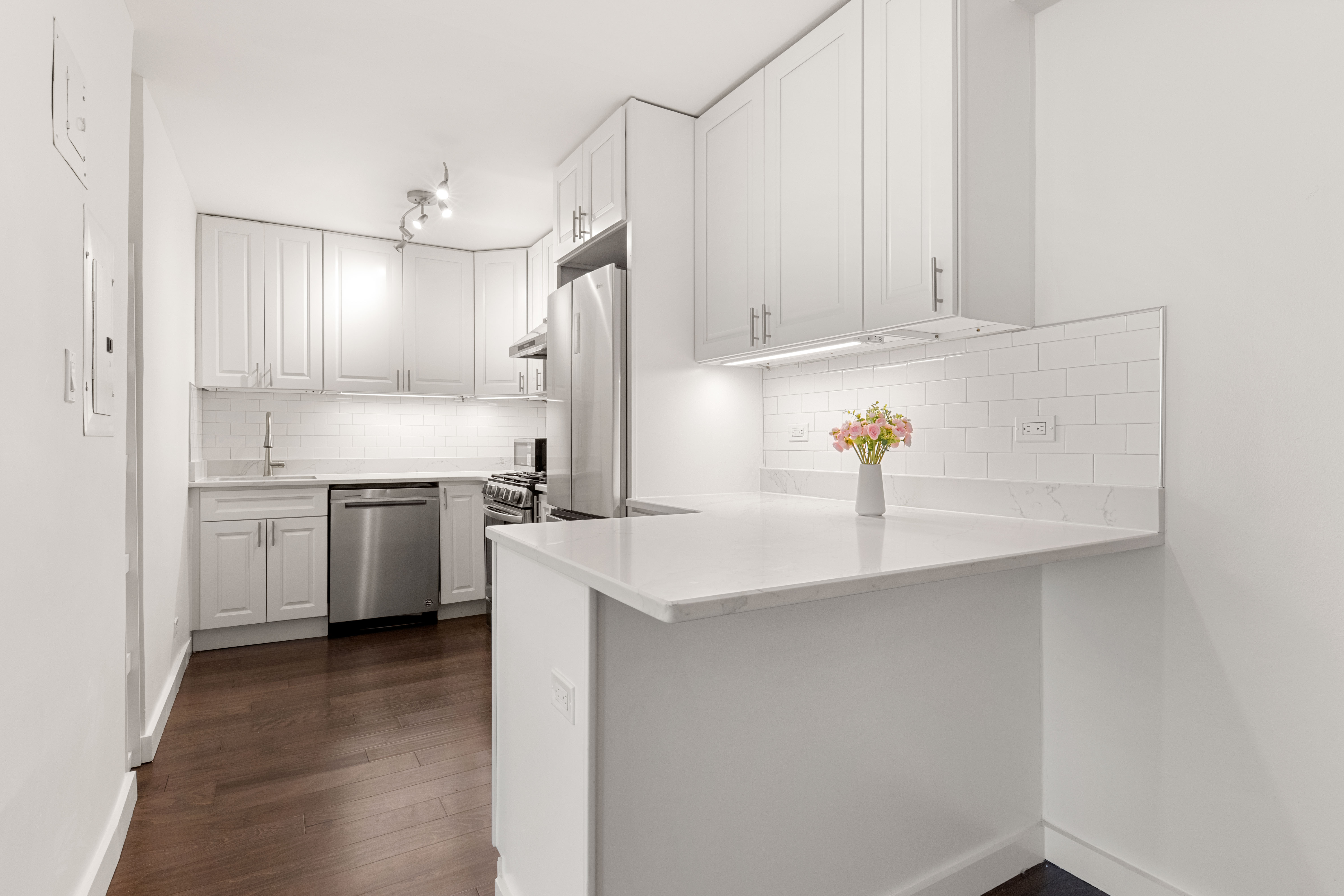 66-36 Yellowstone Boulevard, Unit 24A Queens, NY 11375 - Photo 6 of 20 a kitchen with white cabinets and white appliances