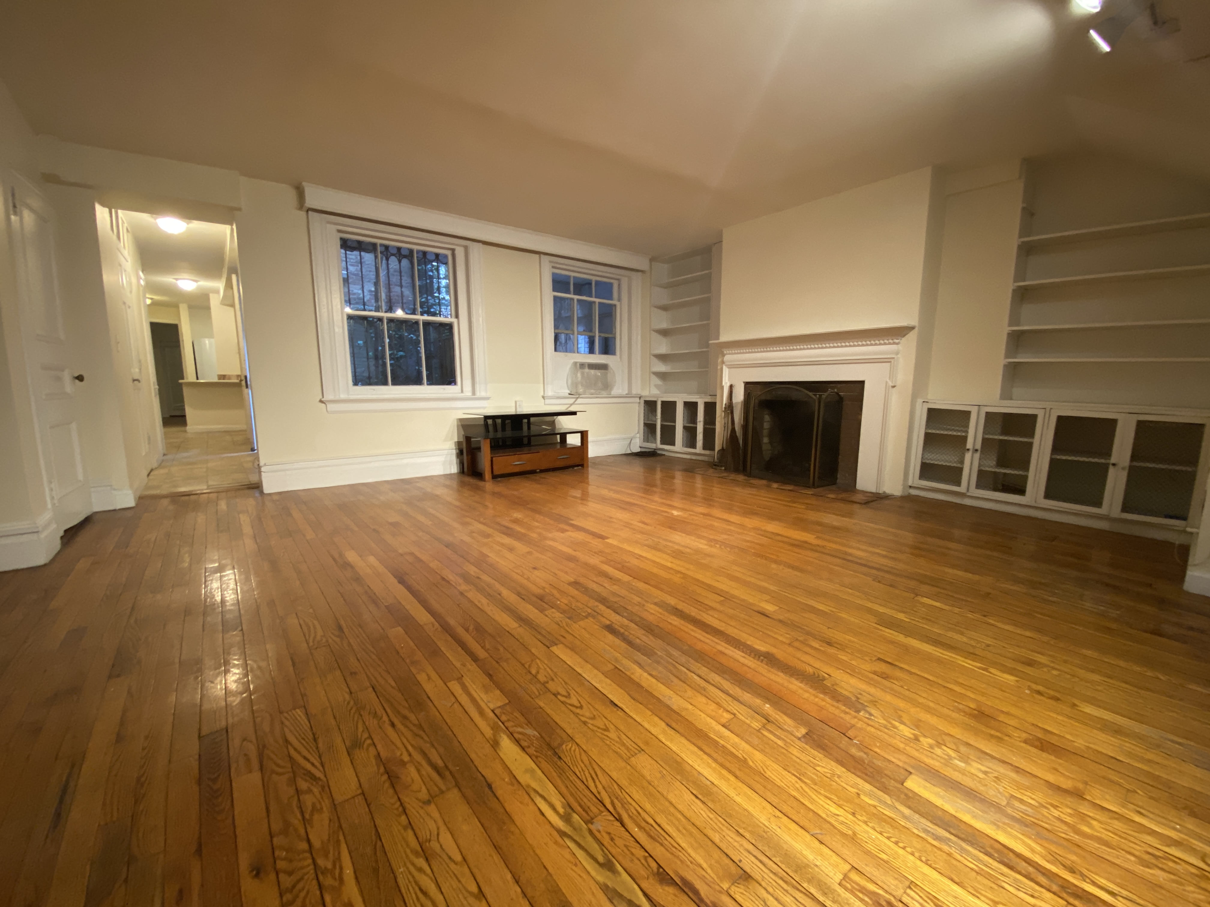 117 East 35th Street, Unit 1 Manhattan, NY 10016 - Photo 2 of 5 a view of a livingroom with wooden floor and a fireplace