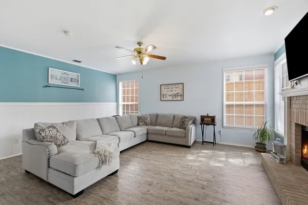 a living room with furniture a fireplace and a flat screen tv