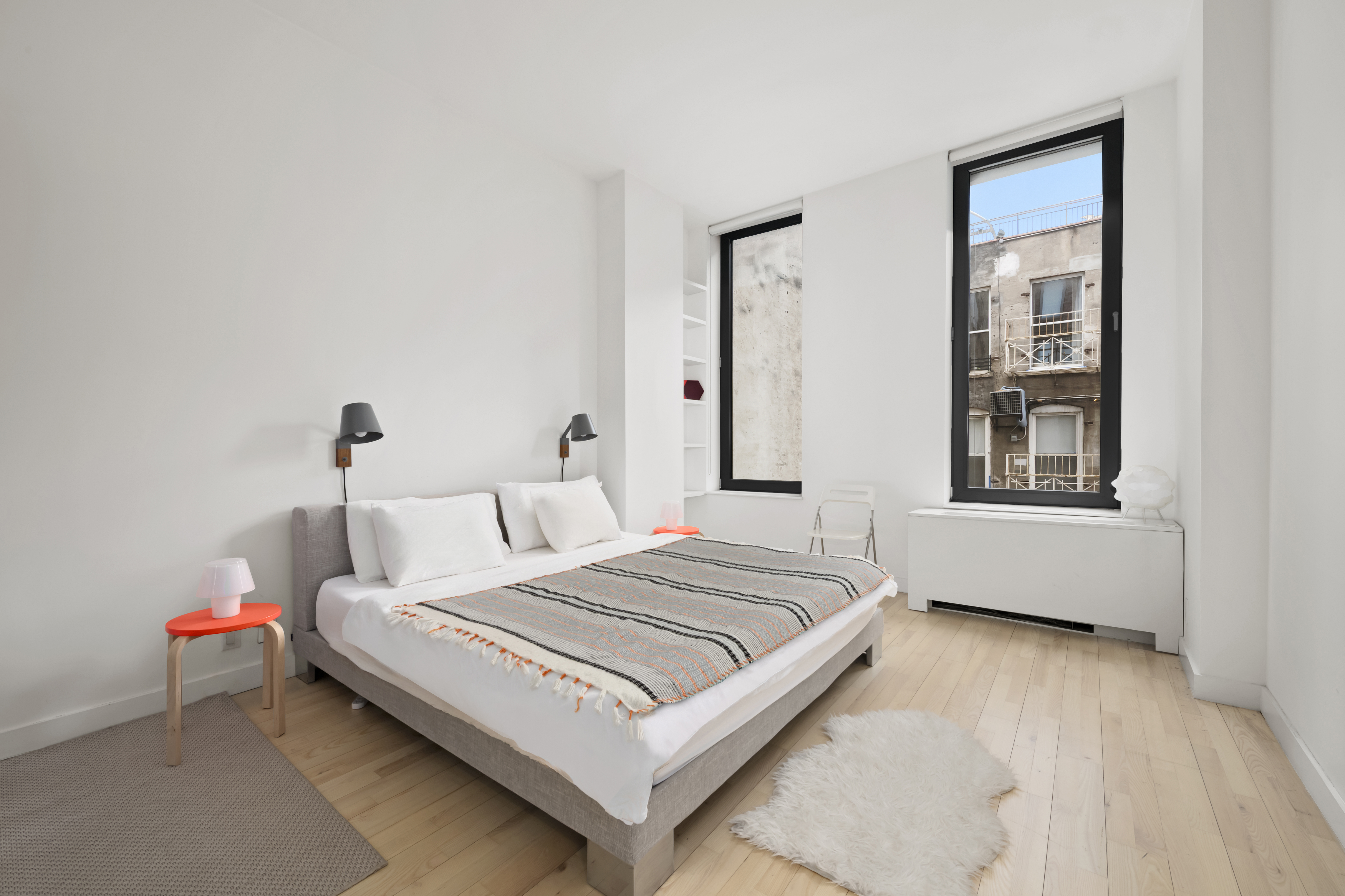 210 Lafayette Street, Unit 6D Manhattan, NY 10012 - Photo 4 of 8 a bedroom with a bed and window