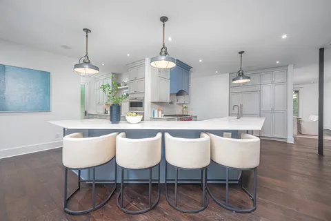 a kitchen with white cabinets and a stove