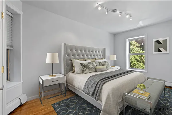 a bedroom with a bed and a lamp