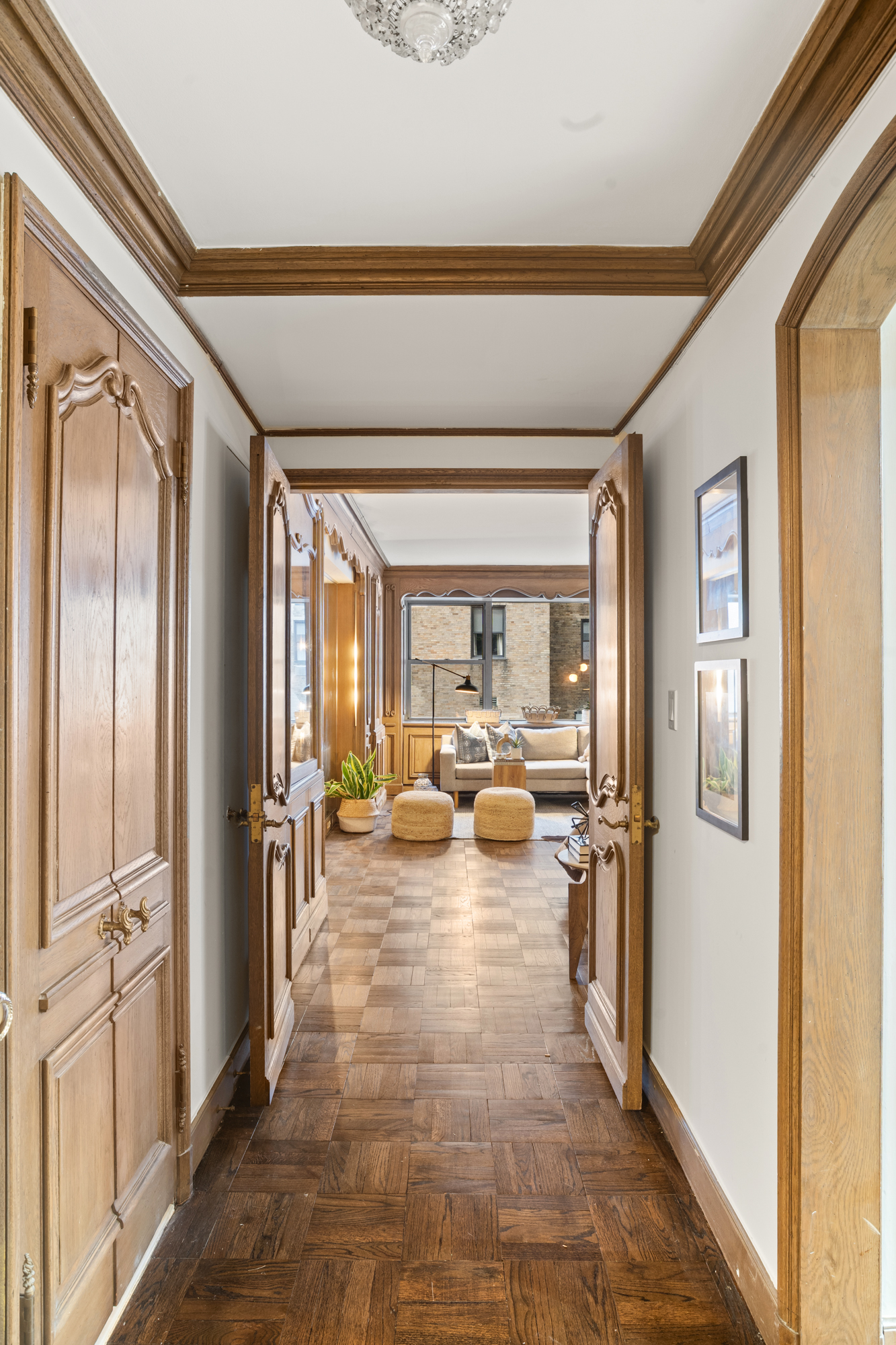 110 East 57th Street, Unit 16B Manhattan, NY 10022 - Photo 2 of 15 a view of a hallway with living room and dining room view with wooden floor