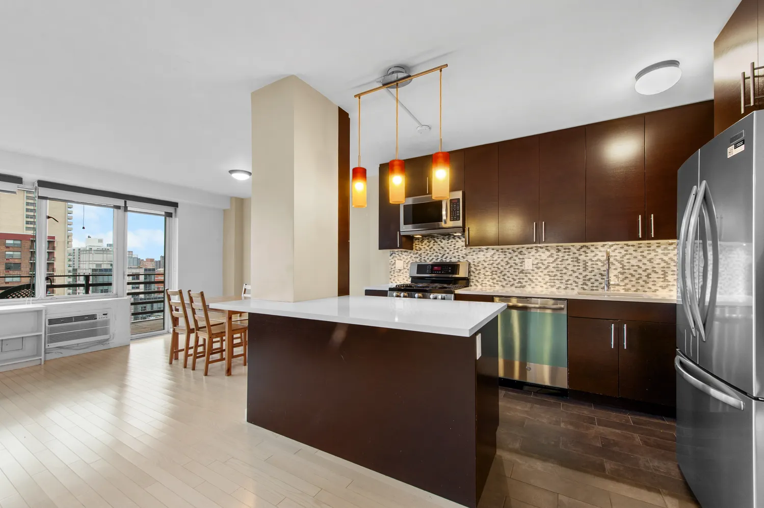 a kitchen with counter top space and wooden floor